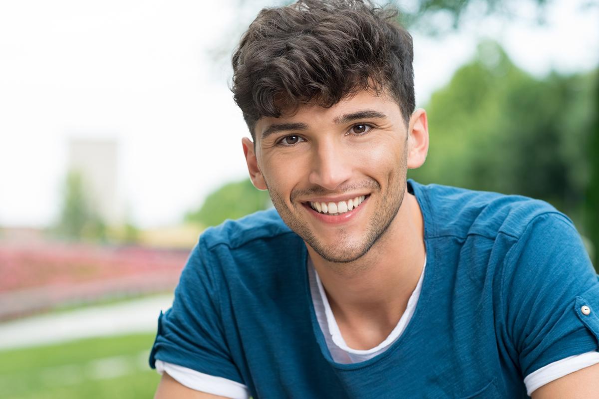 a close up of a man in a blue shirt