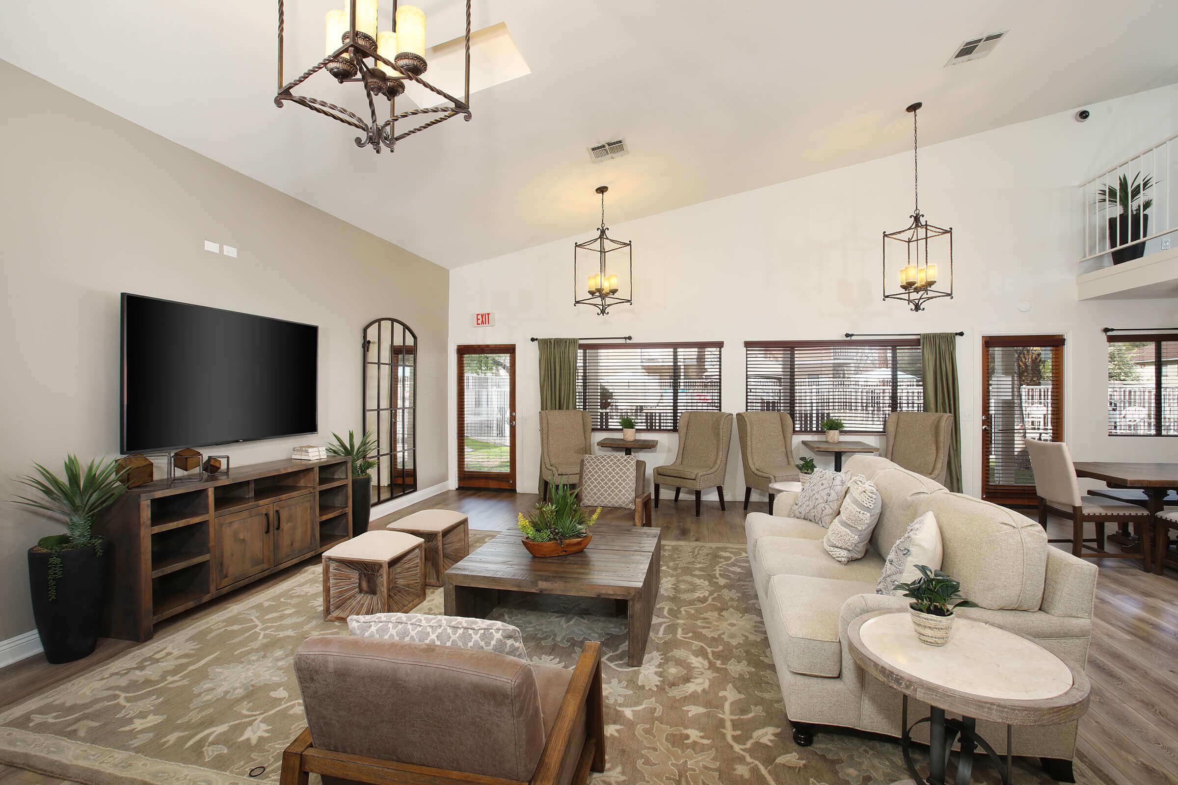 a living room filled with furniture and a flat screen tv