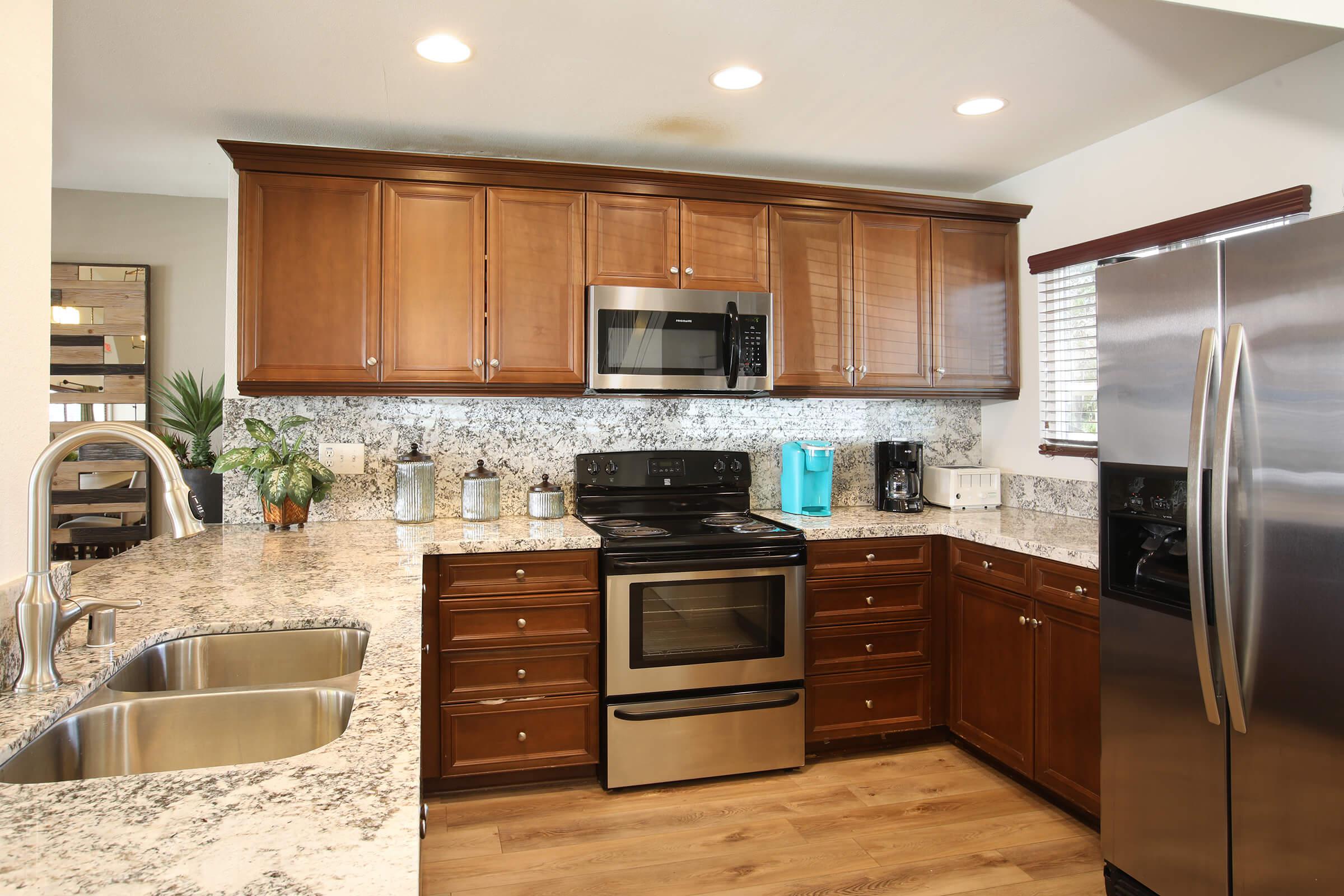 a modern kitchen with stainless steel appliances and wooden cabinets