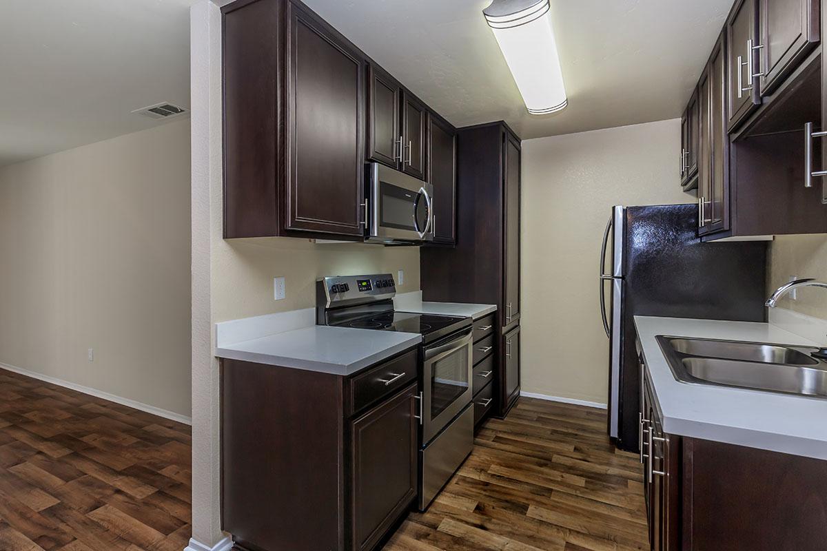 a kitchen with a sink and a mirror