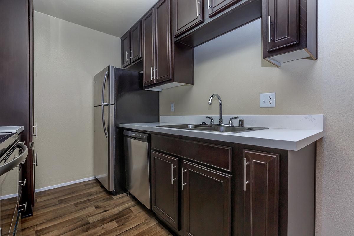 a kitchen with a sink and a mirror