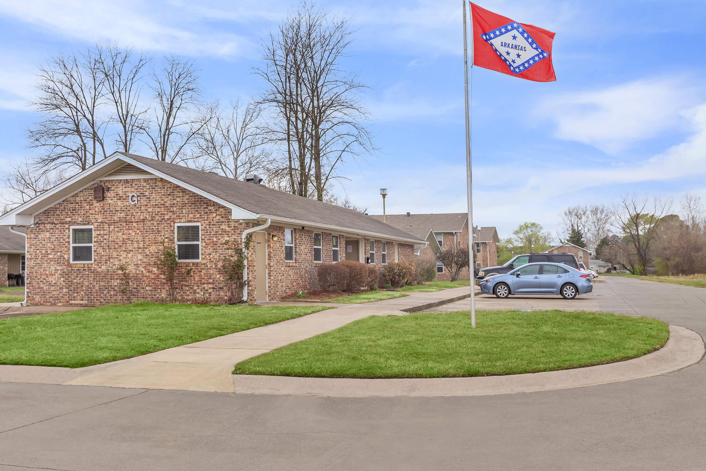 a house that has a sign on the side of a road