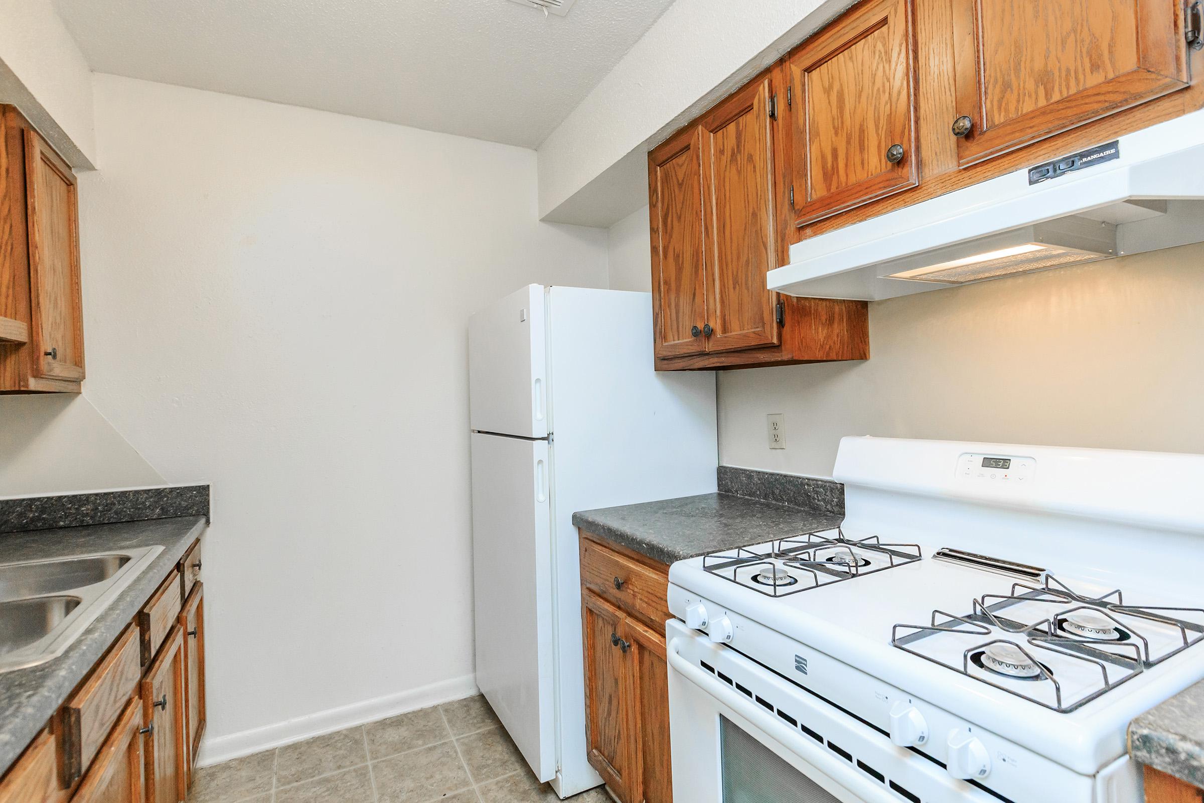 a kitchen with a stove sink and refrigerator