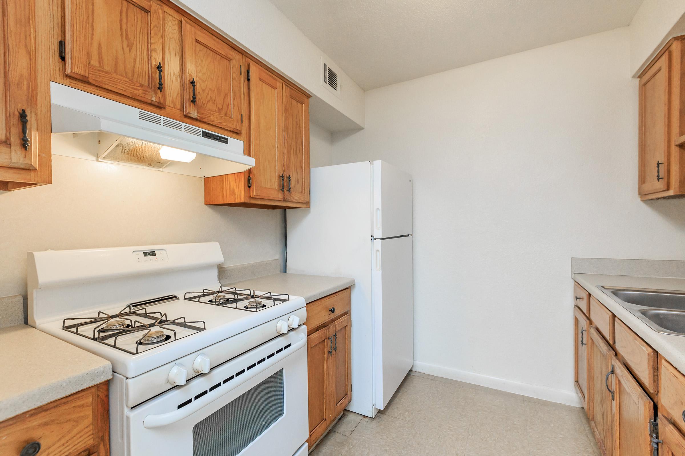 a kitchen with a stove top oven sitting inside of a refrigerator