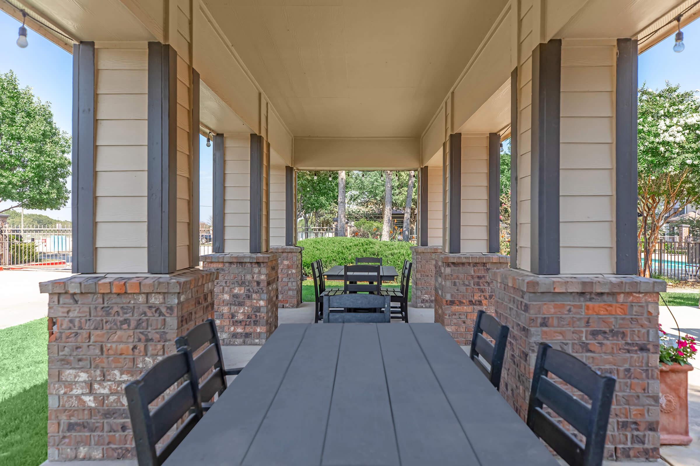 a bench in front of a brick building