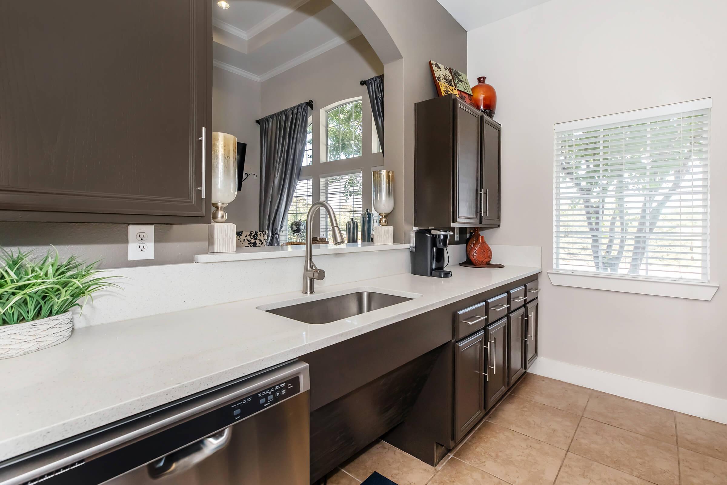 a kitchen with a sink and a window