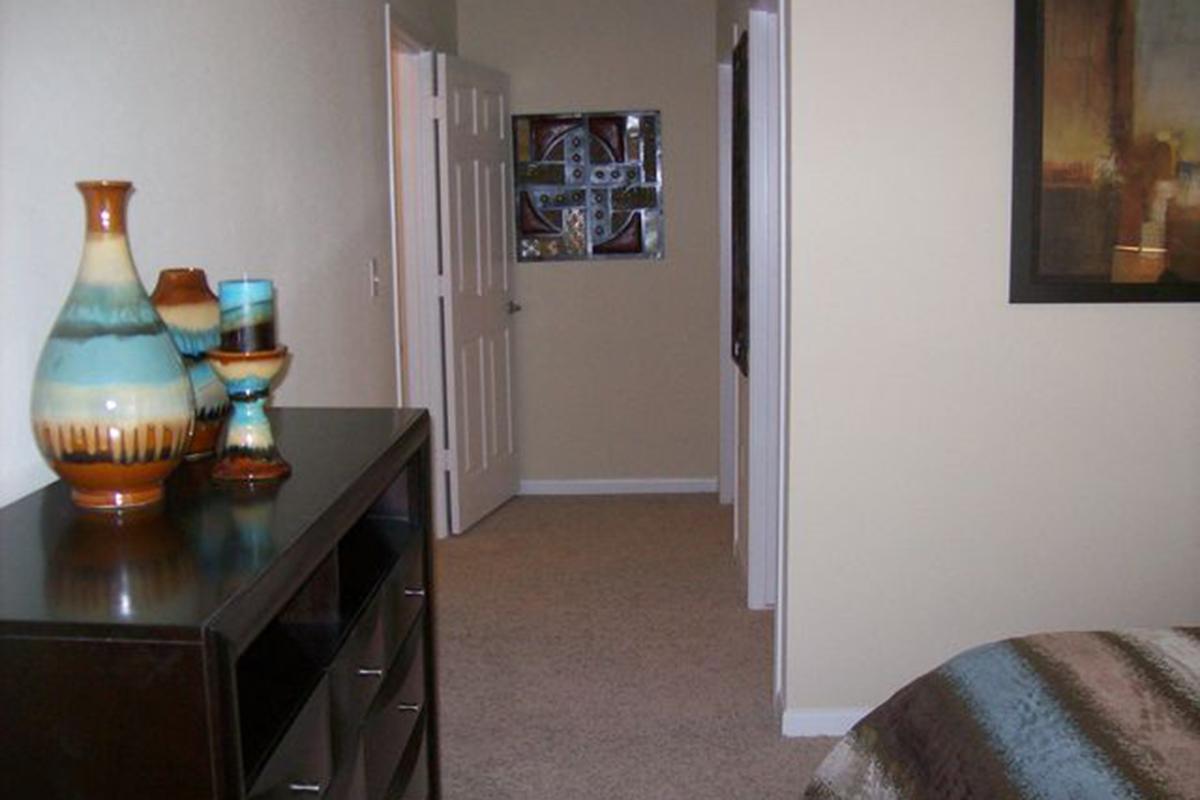 a room filled with furniture and vase on a table