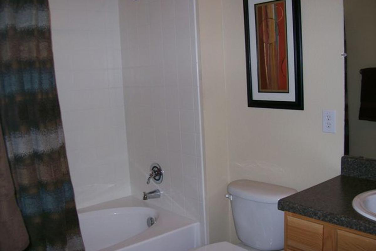 a white tub sitting next to a sink