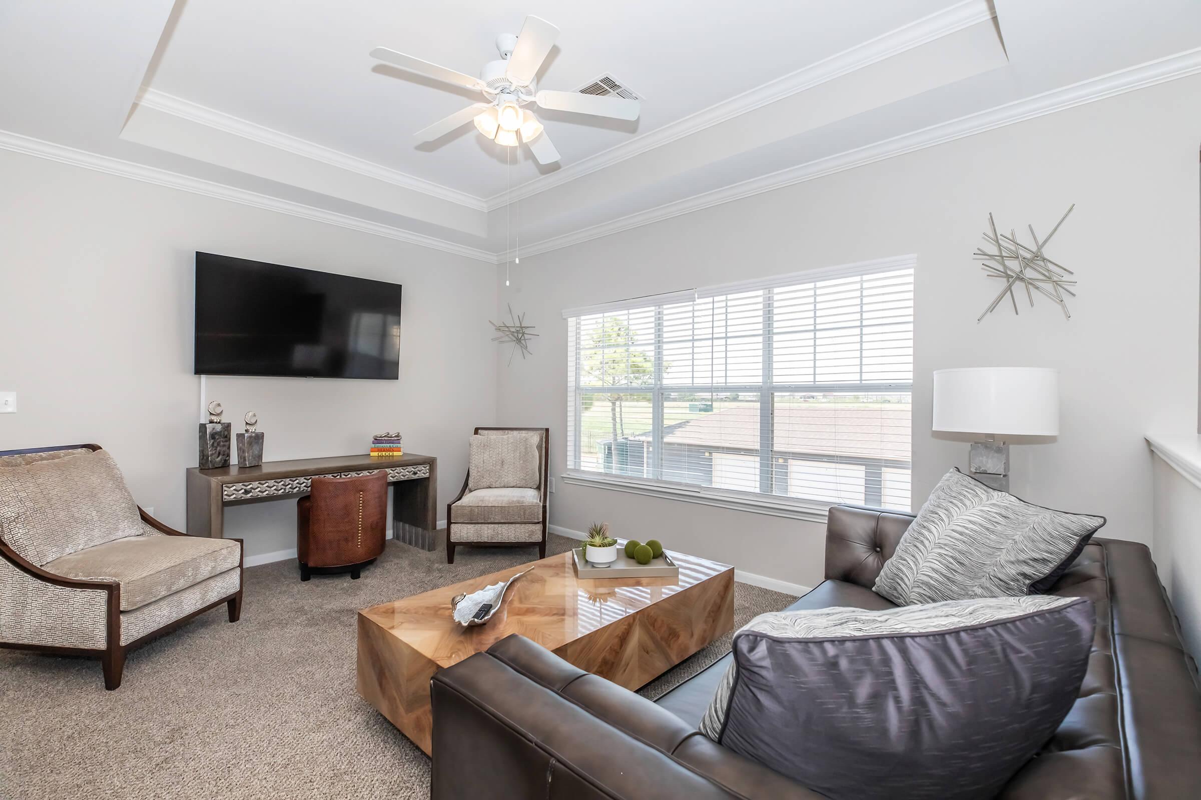 a living room filled with furniture and a large window