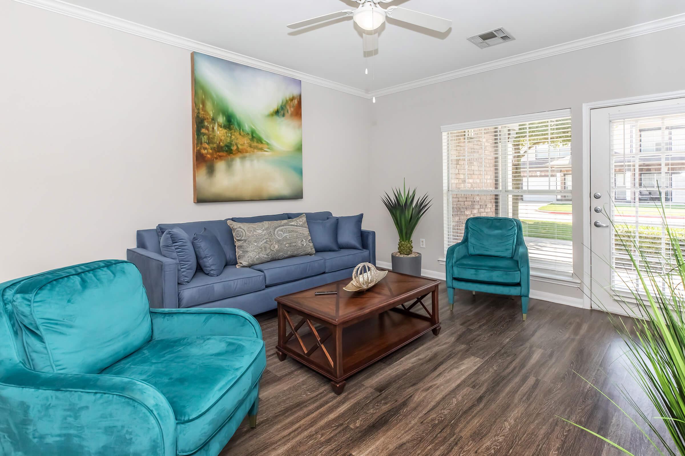 a living room with a bed and a window