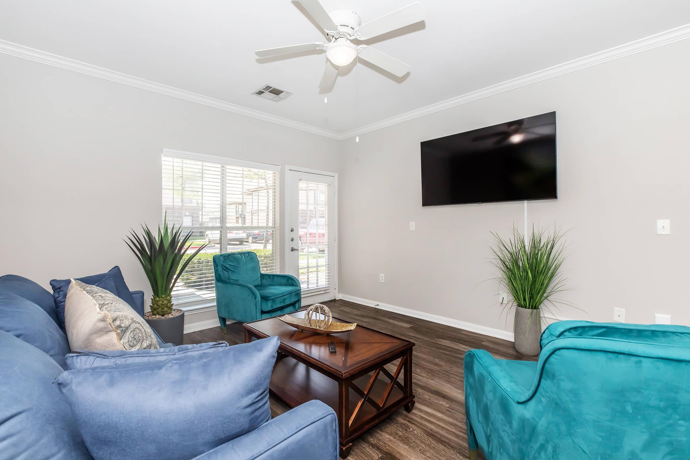 a living room filled with furniture and a large window