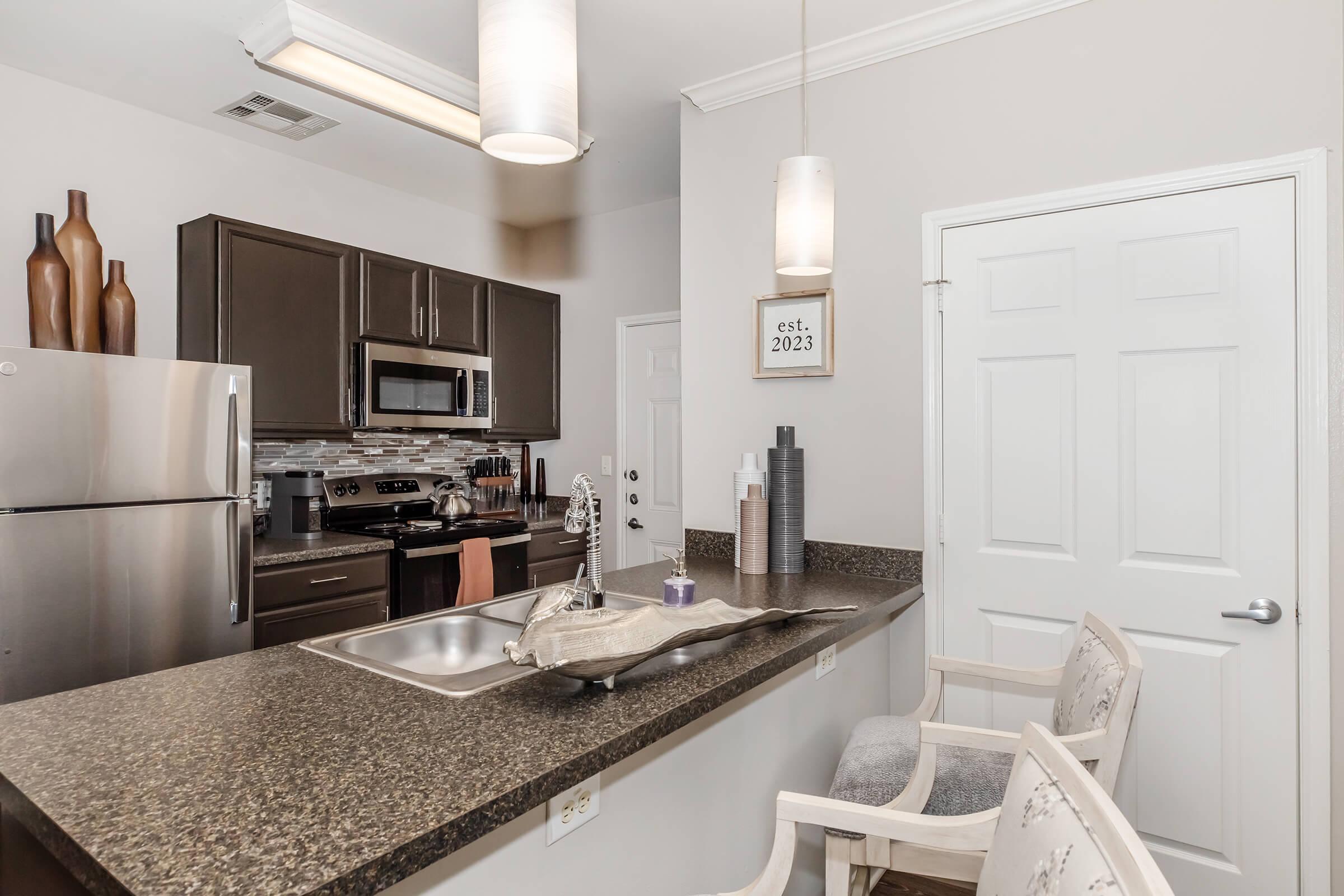 a kitchen with a sink and a mirror