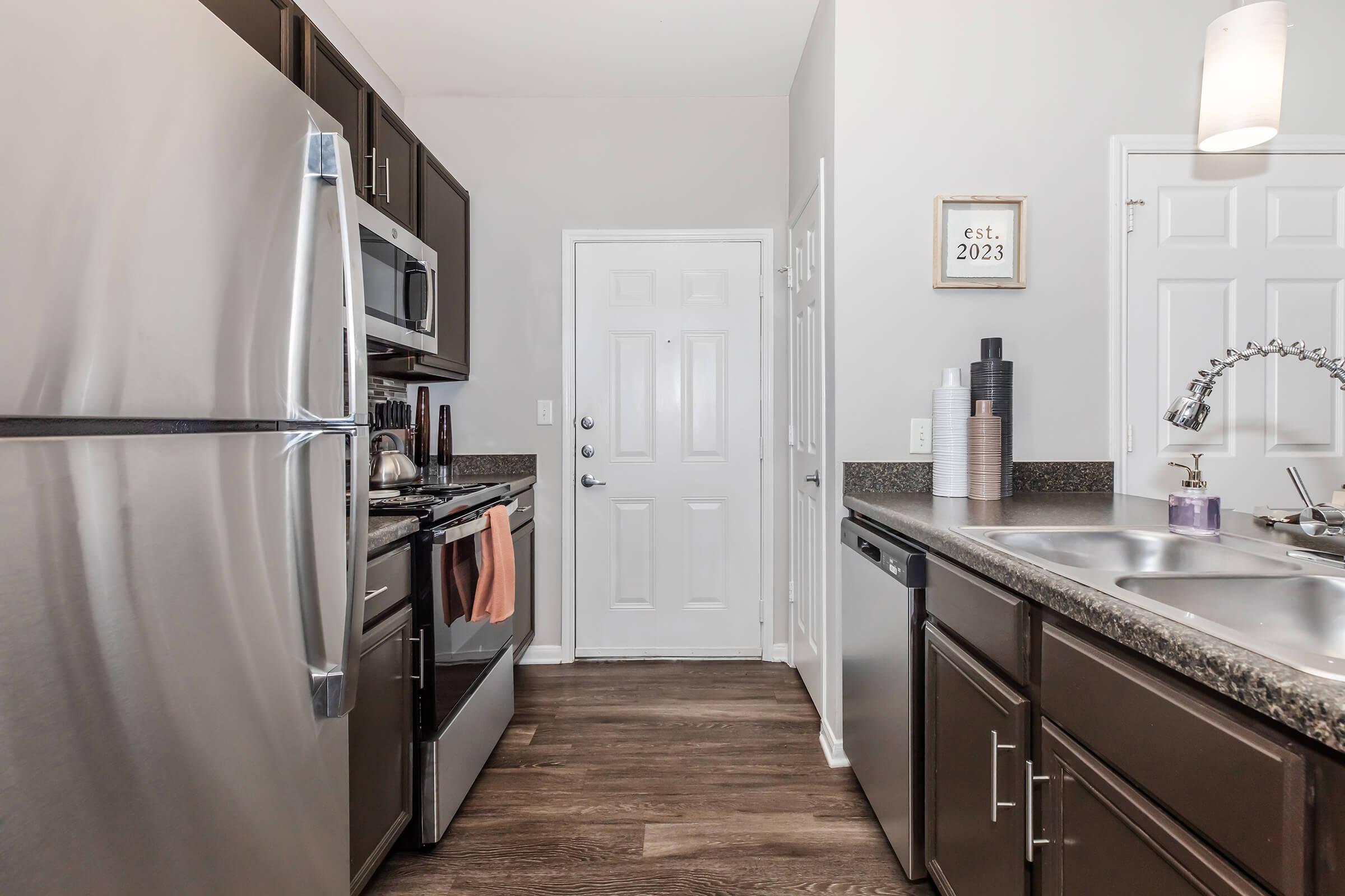 a kitchen with a sink and a refrigerator