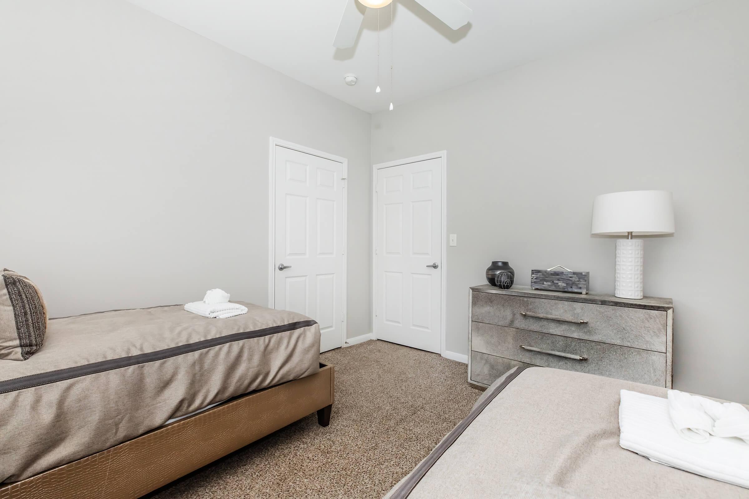 a bedroom with a bed and desk in a room