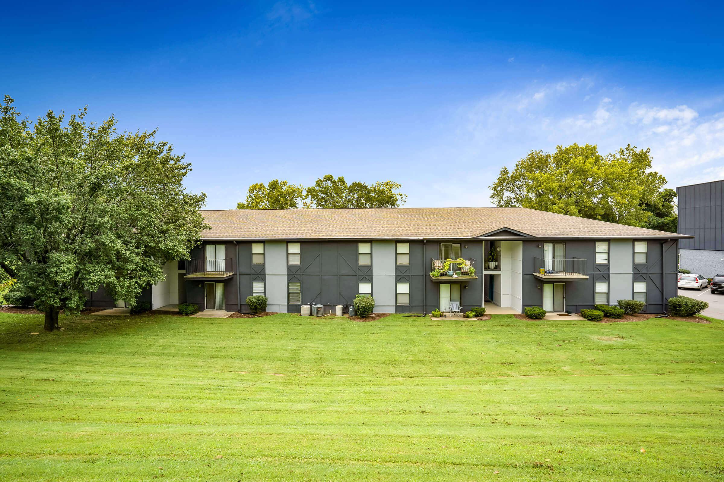 a large lawn in front of a house with Mission House in the background