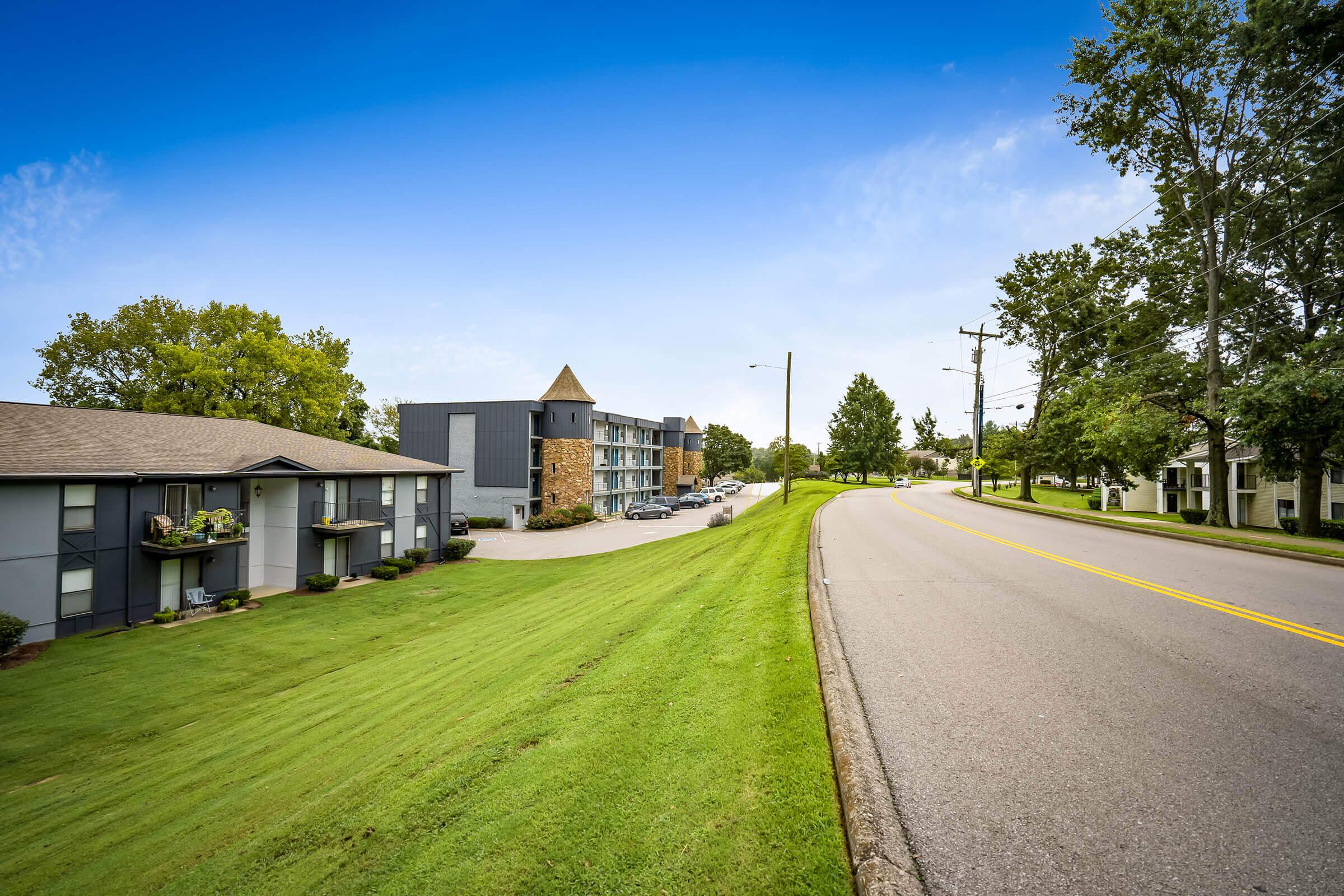 a house that has a sign on the side of a road