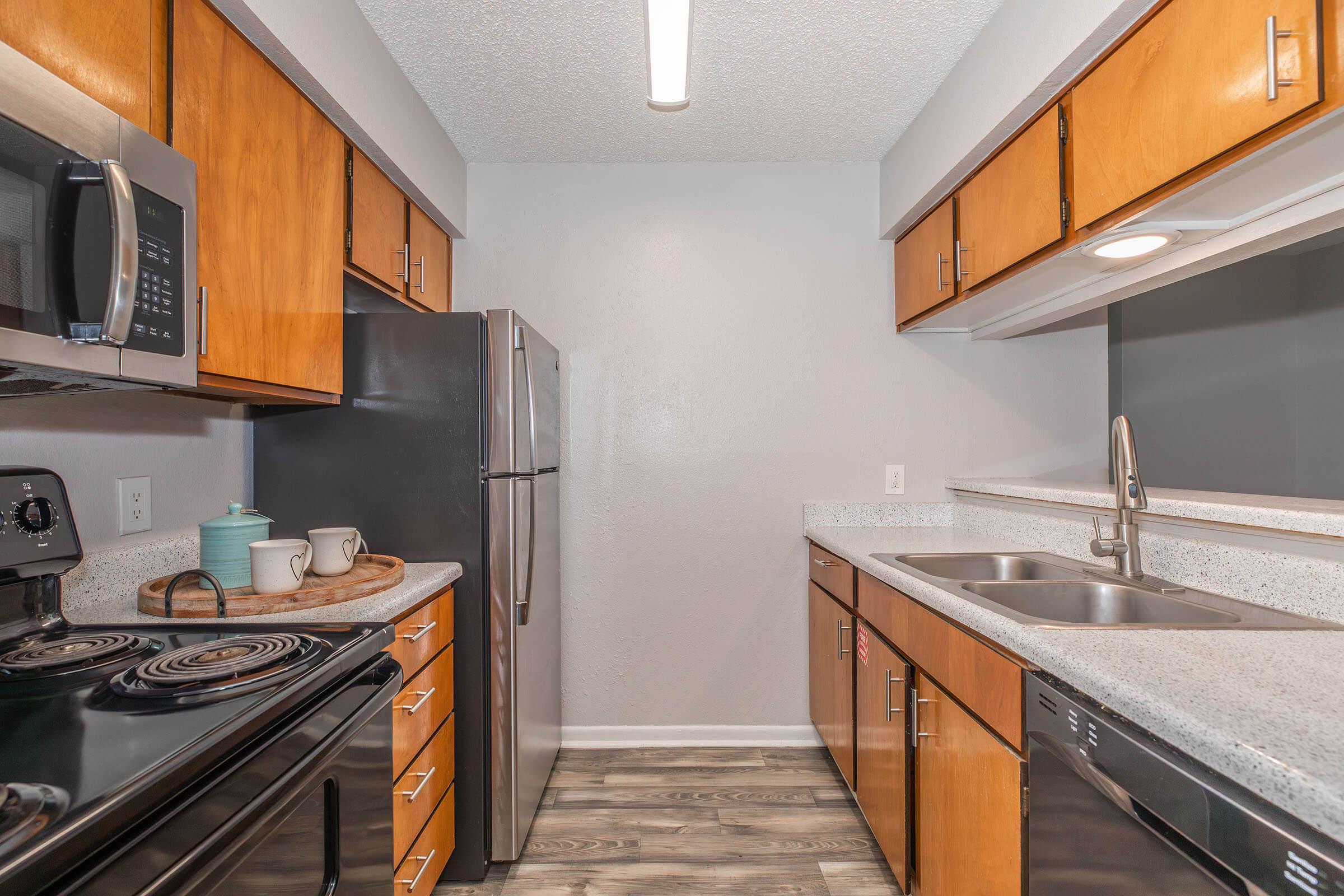 a kitchen with stainless steel appliances and wooden cabinets