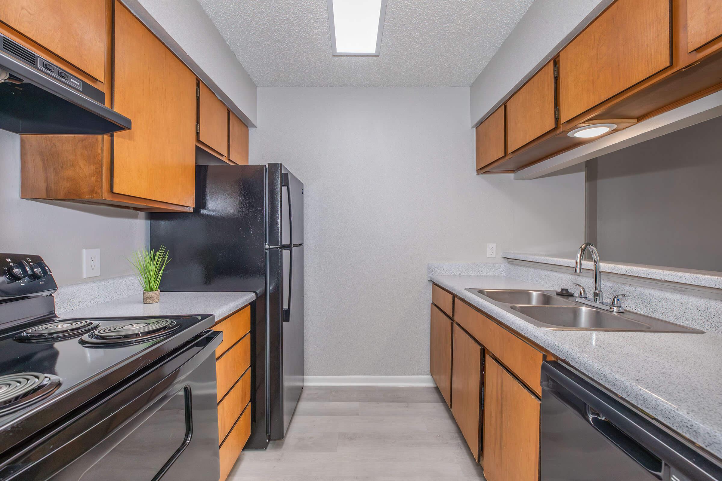 a kitchen with stainless steel appliances and wooden cabinets