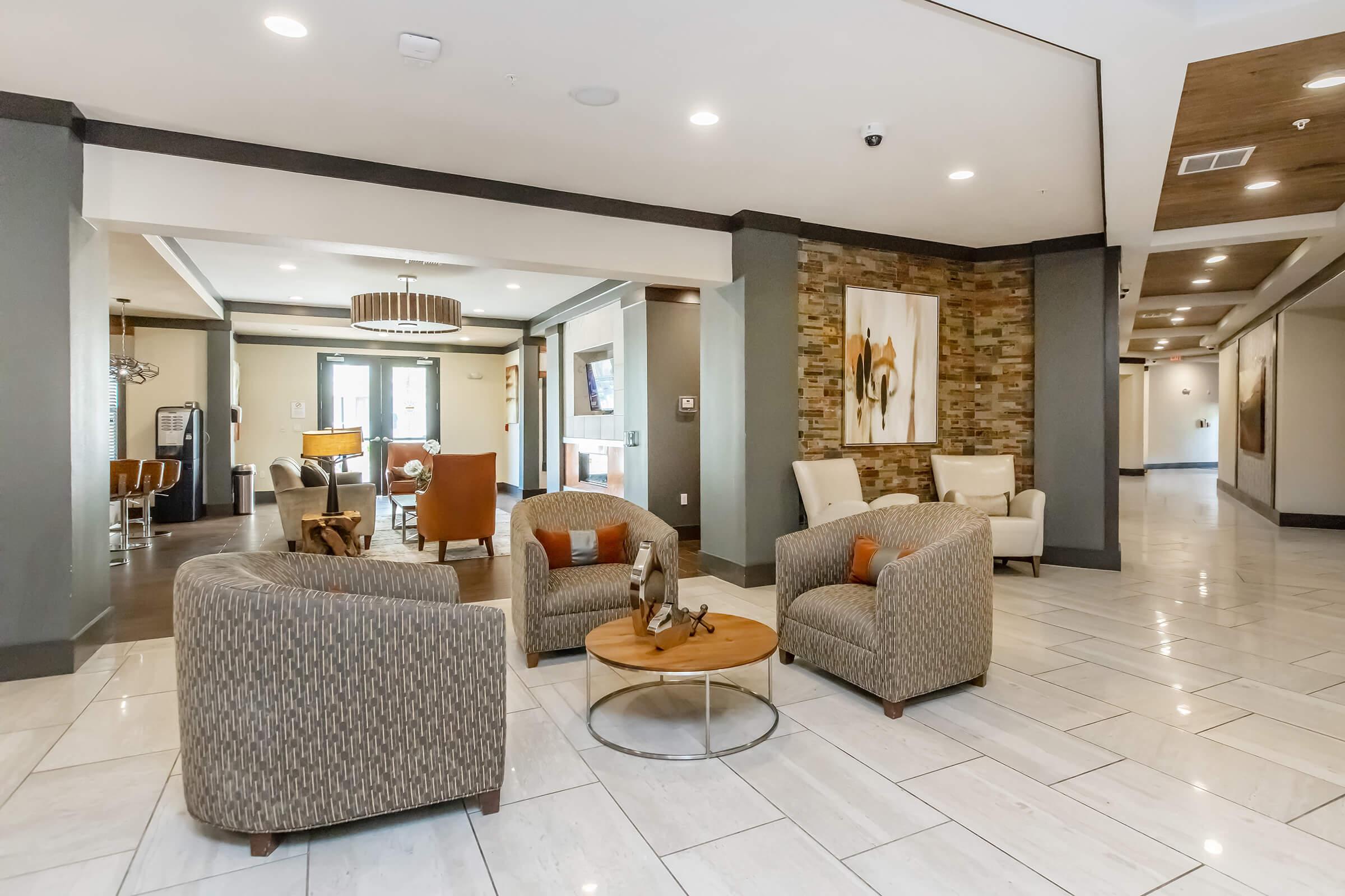 a living room filled with furniture and a large window