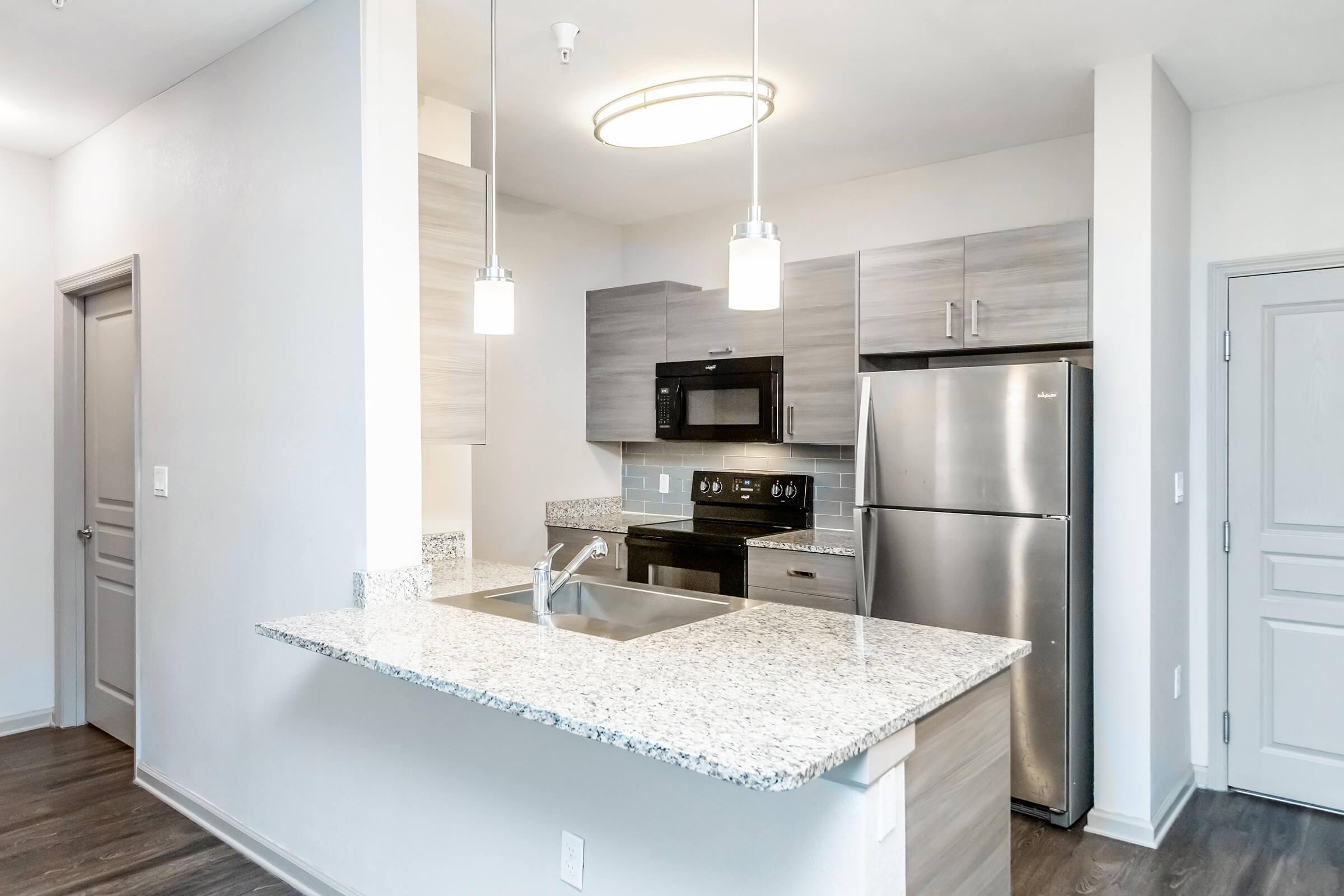 a kitchen with a sink and a mirror