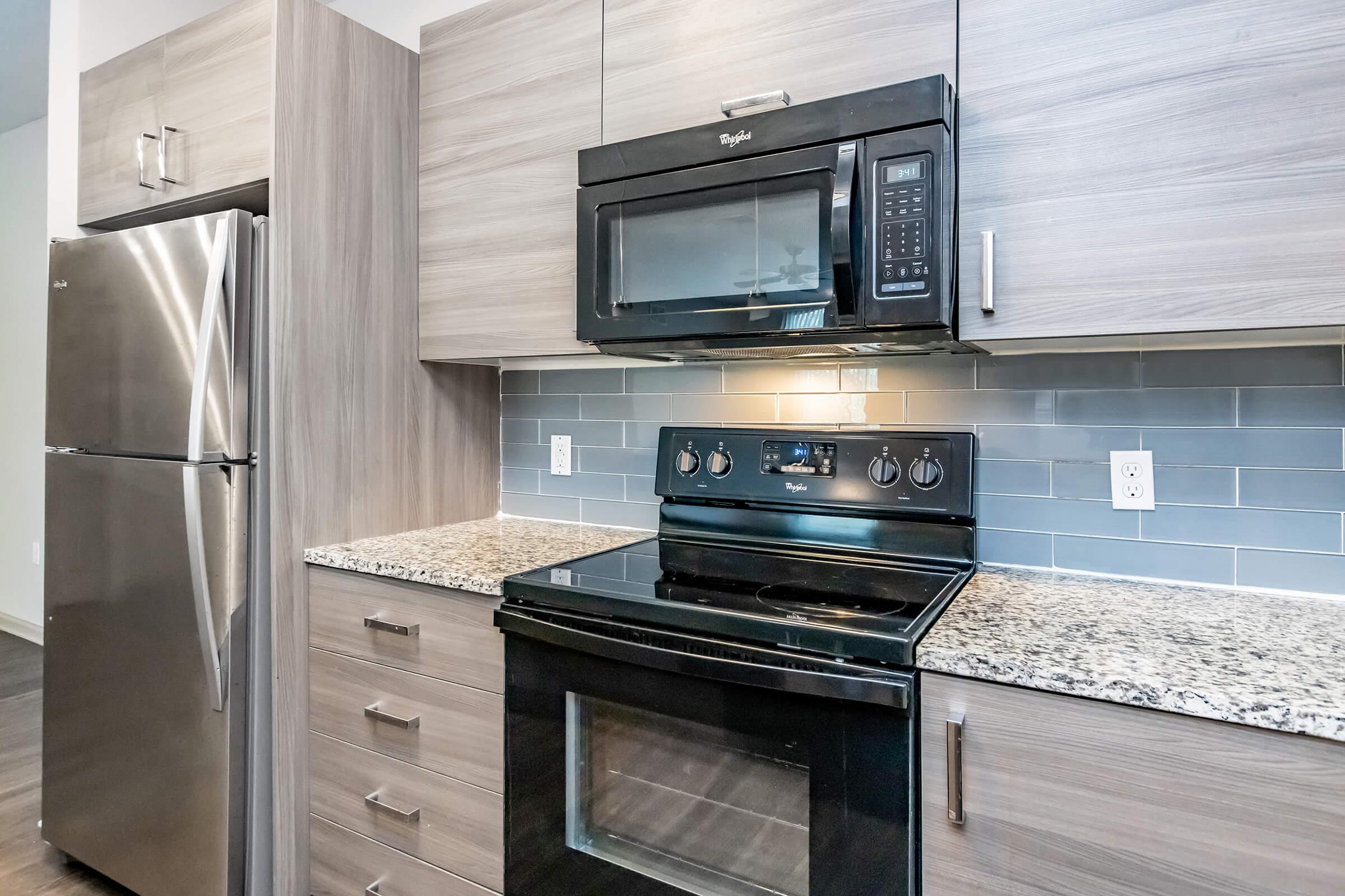 a stove top oven sitting inside of a kitchen