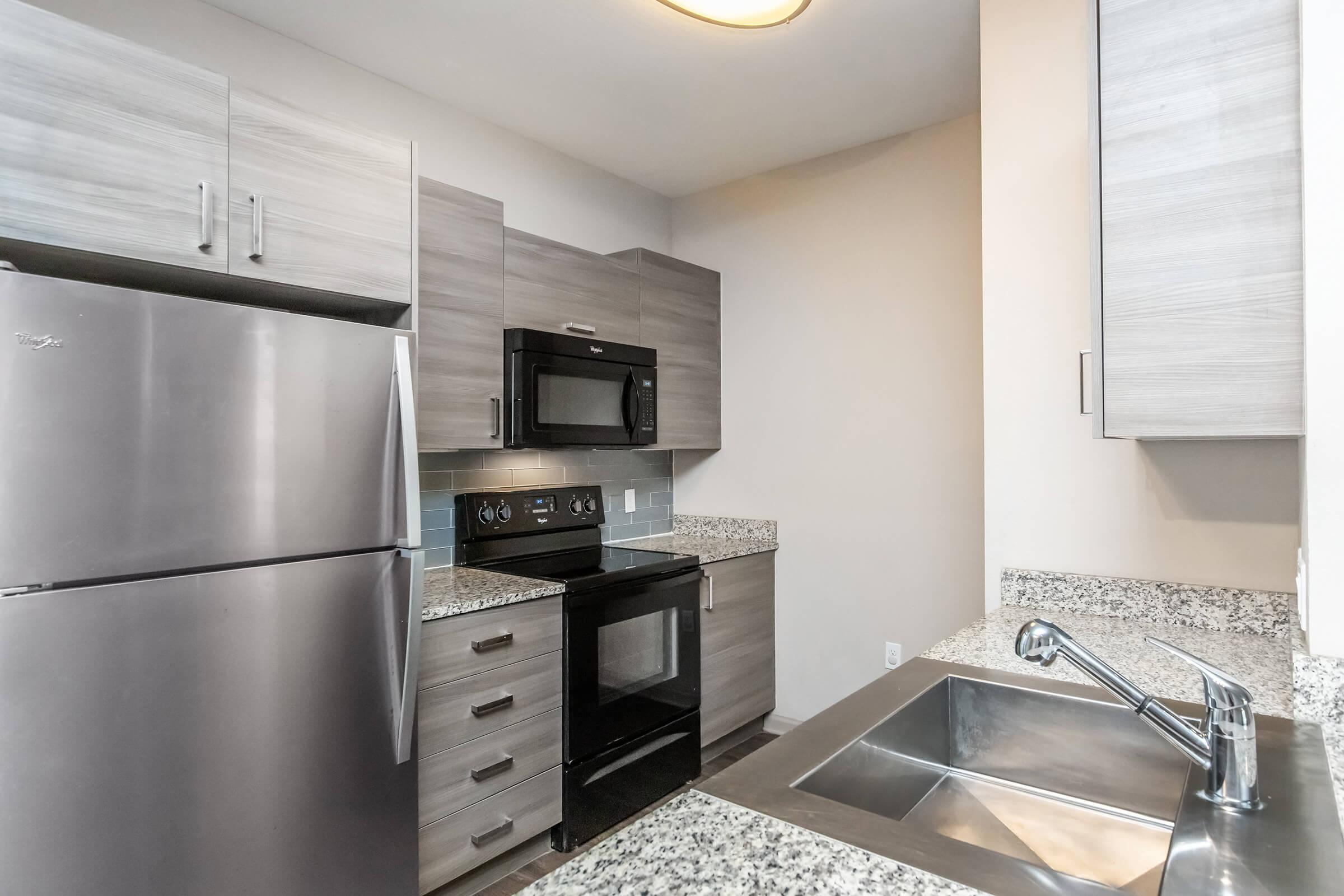 a kitchen with a sink and a refrigerator