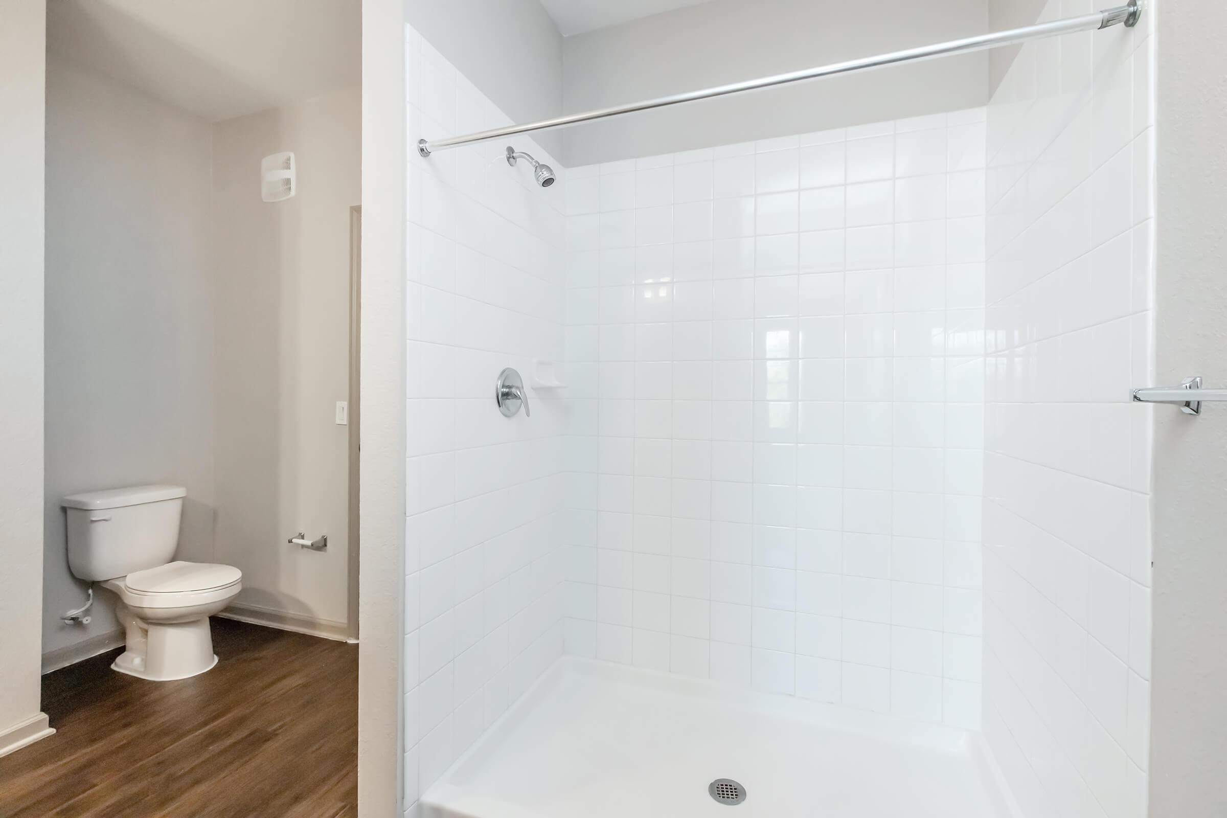 a small rest room with a sink and a shower