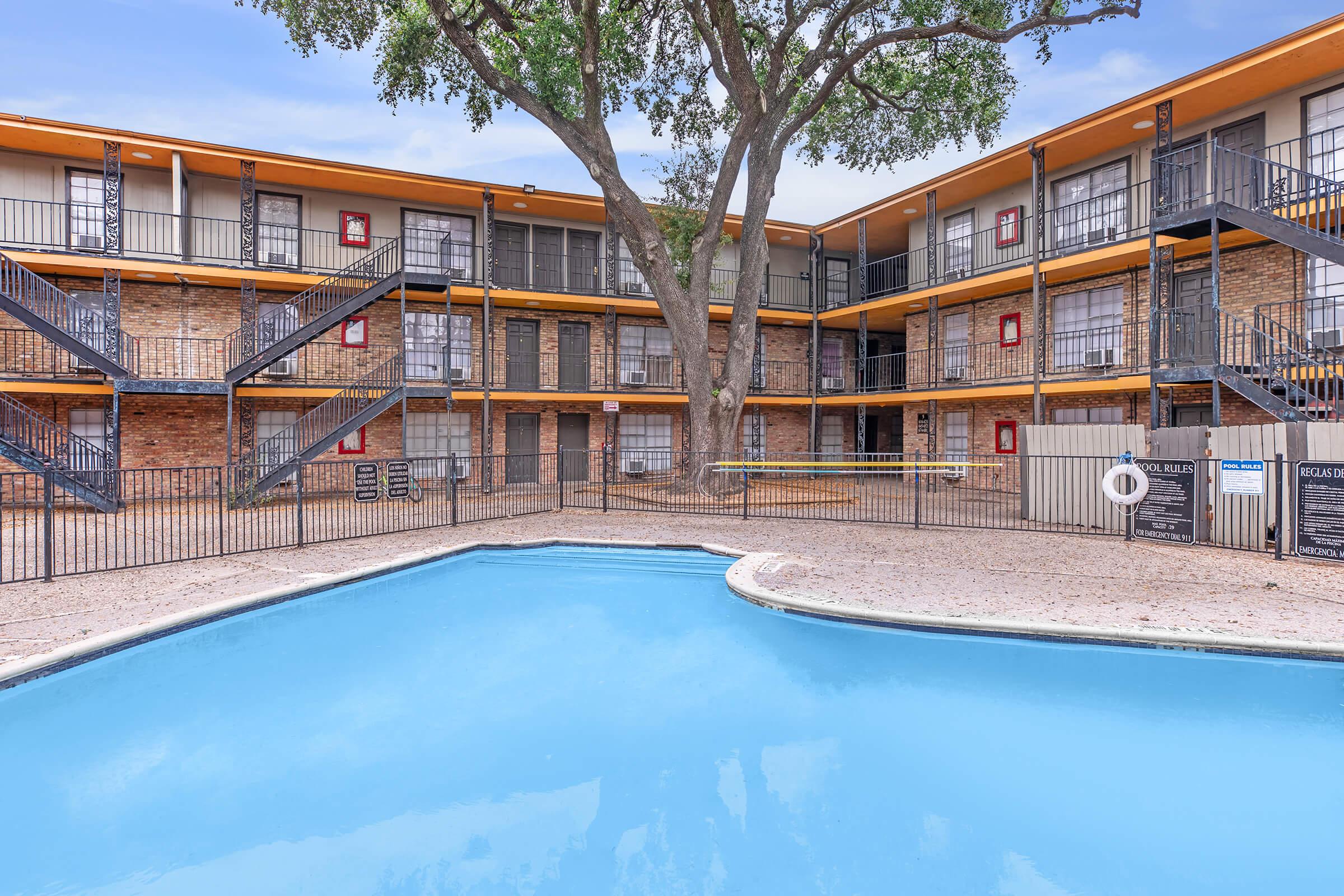 a house with a pool in front of a building