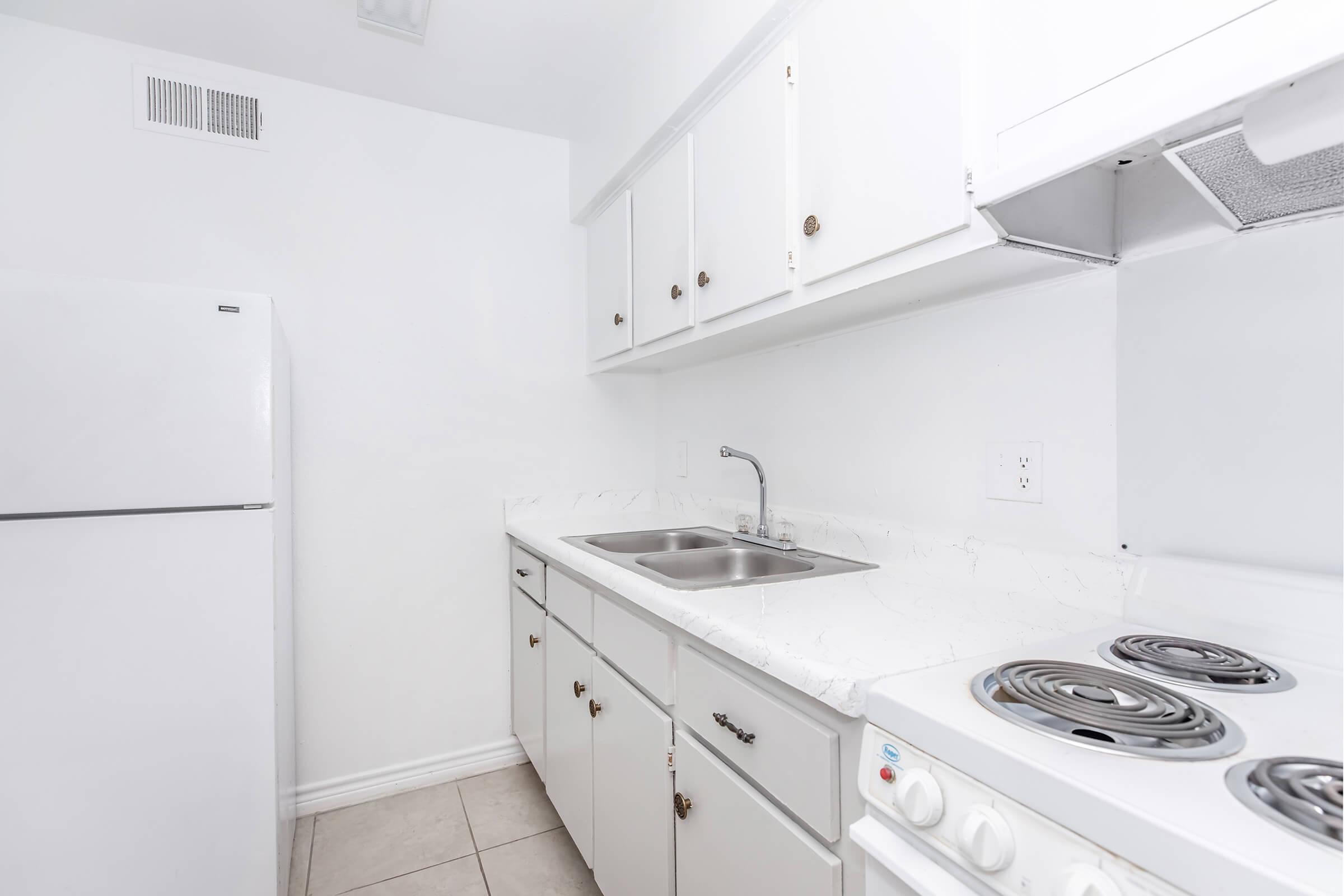 a stove top oven sitting inside of a kitchen