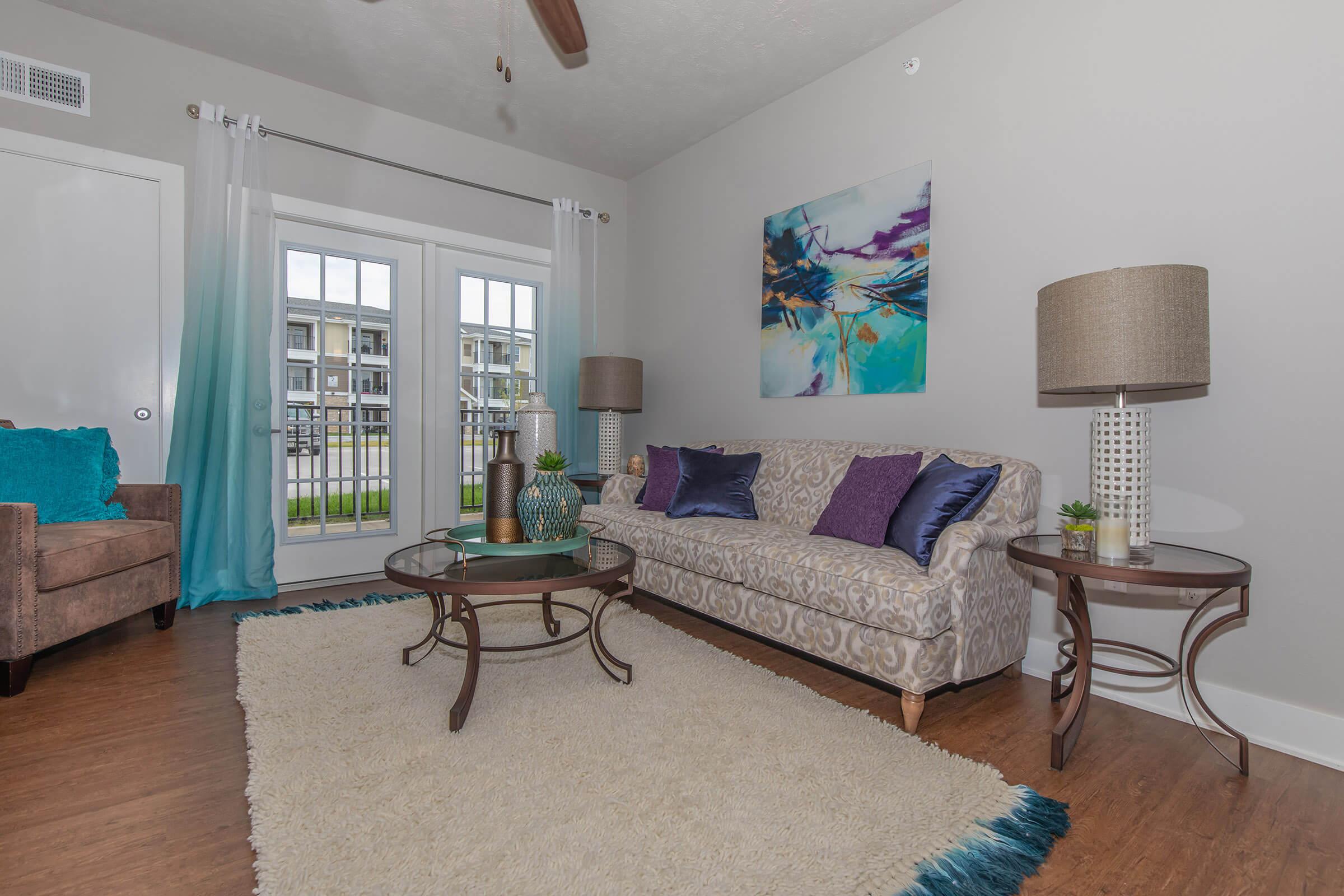 a living room filled with furniture and a rug