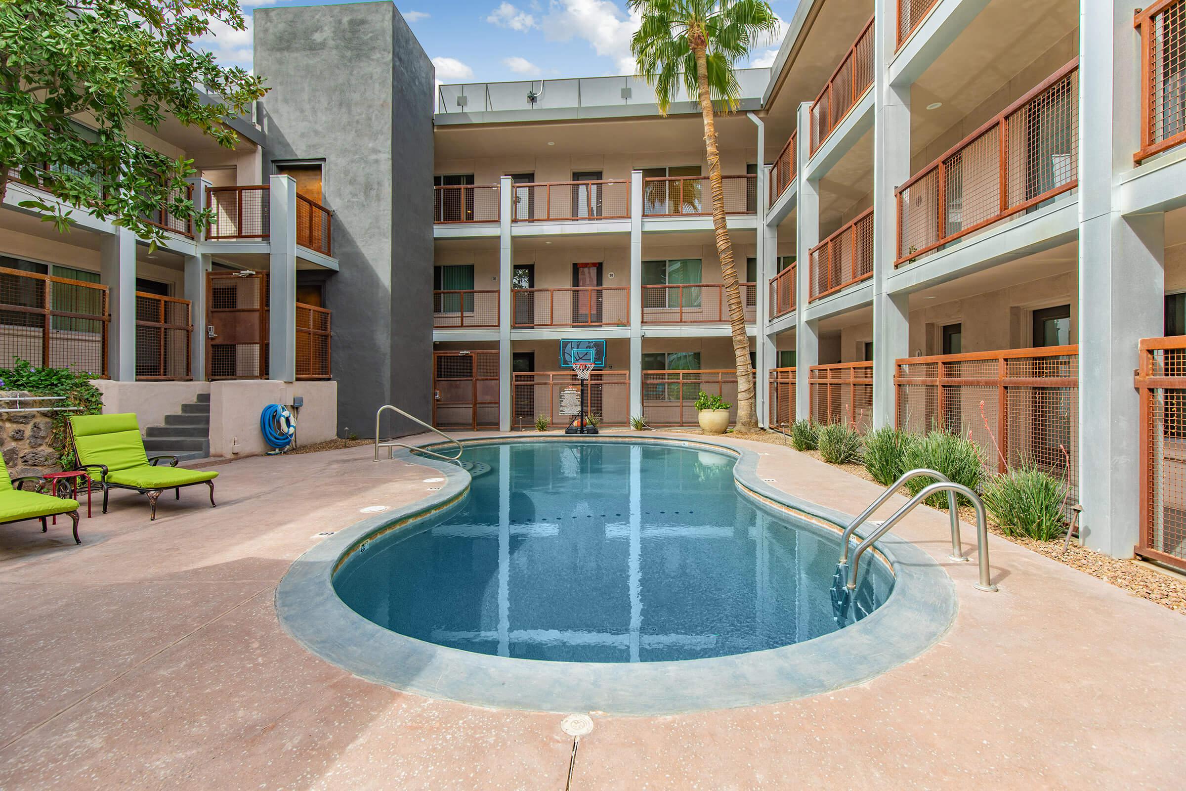 a building with a pool in front of a house