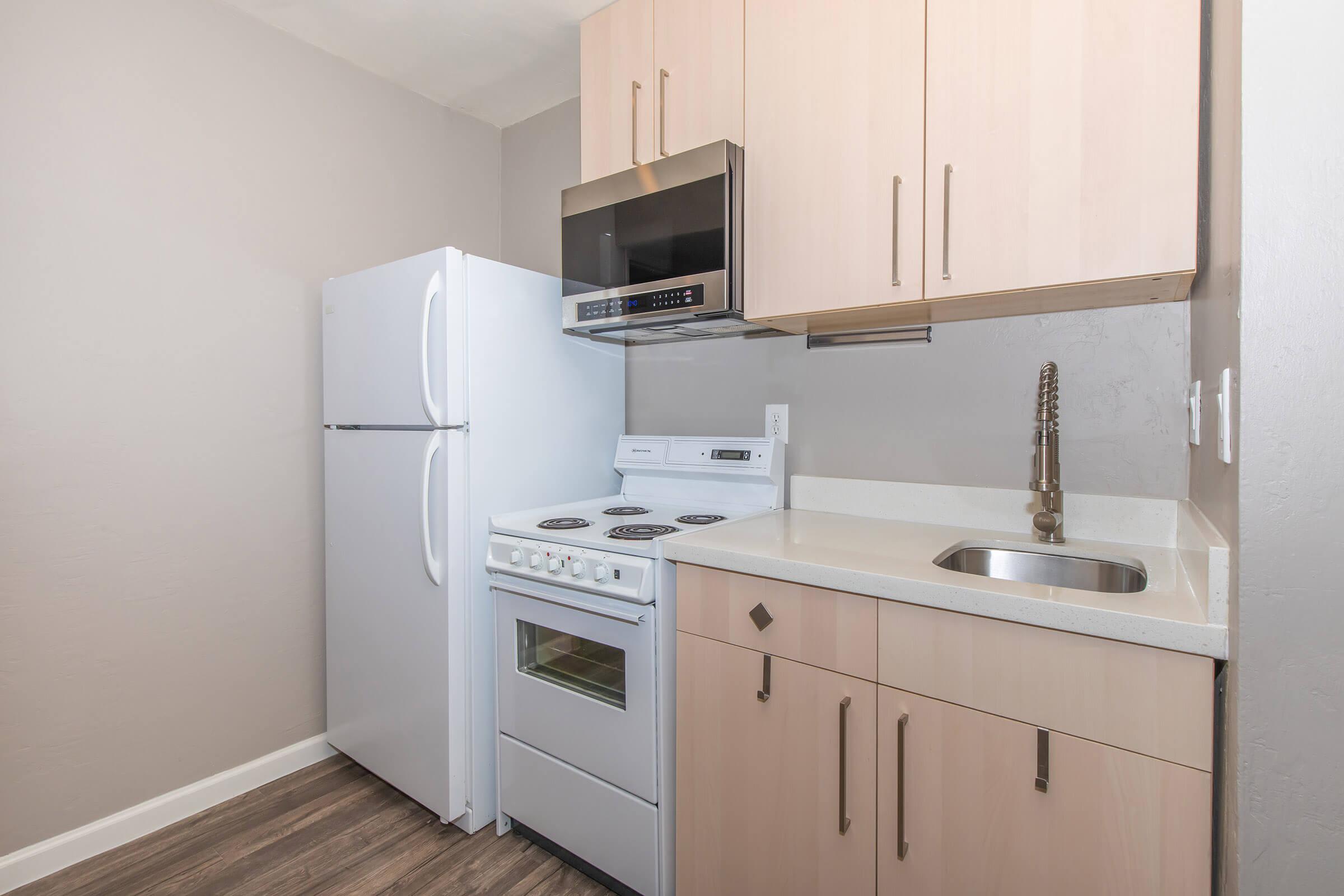 a kitchen with a sink and a refrigerator