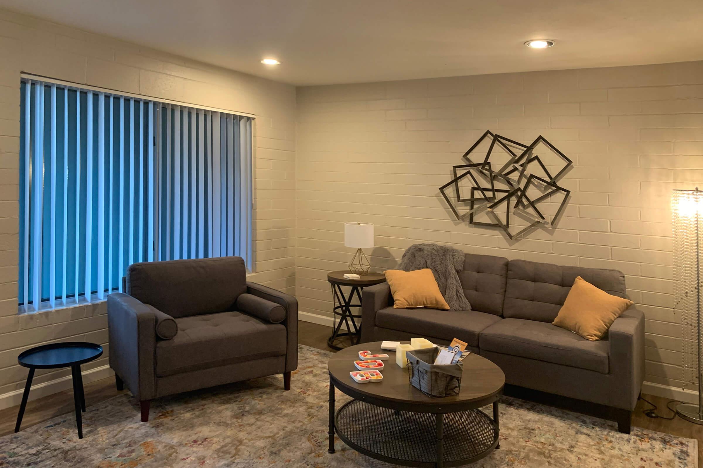 a living room filled with furniture and a flat screen tv