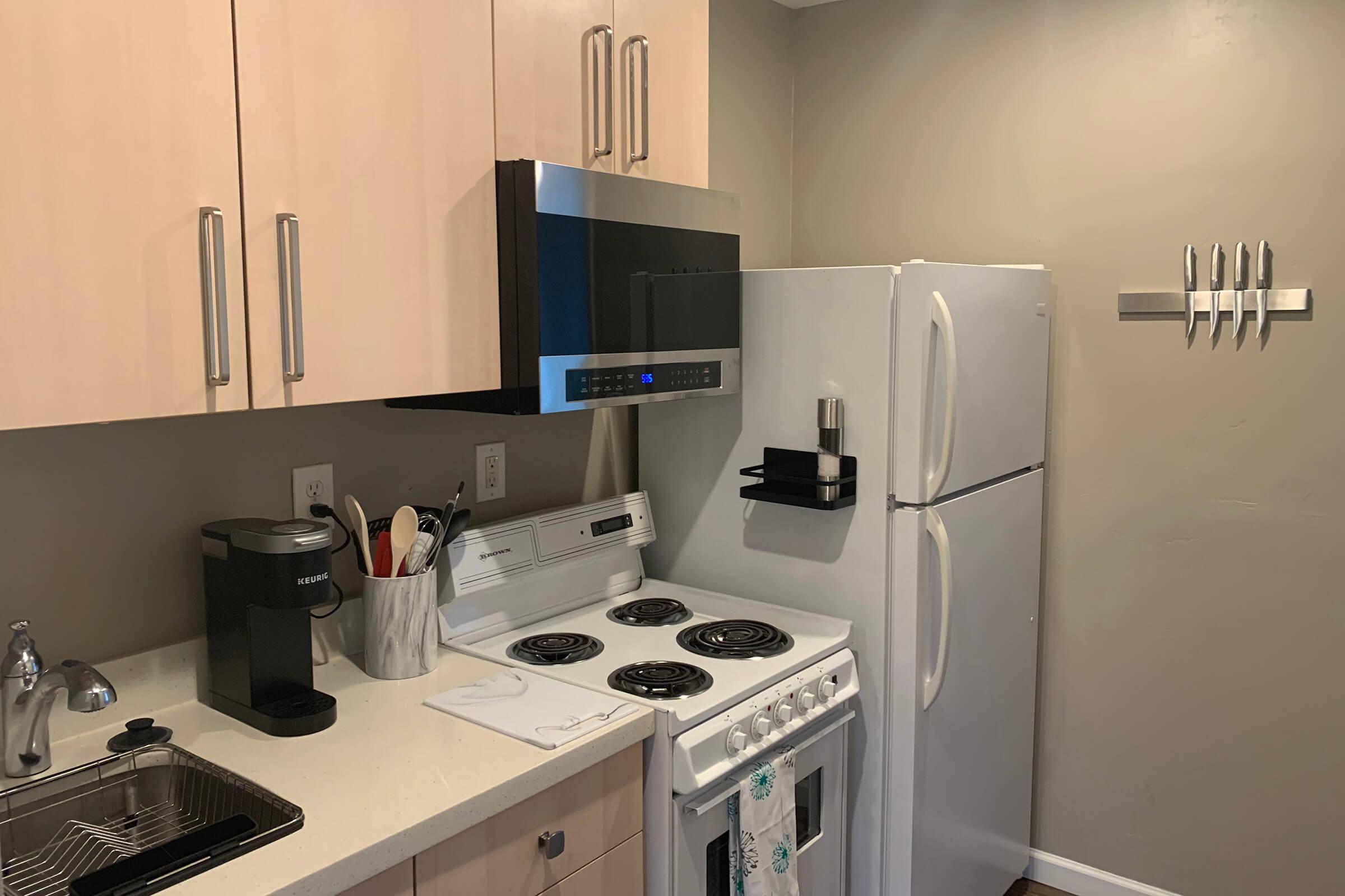 a kitchen with a stove sink and refrigerator