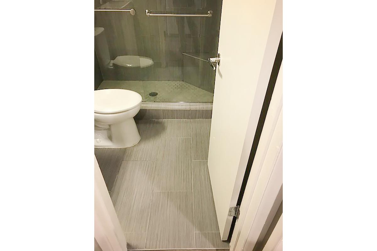 a white sink sitting next to a shower