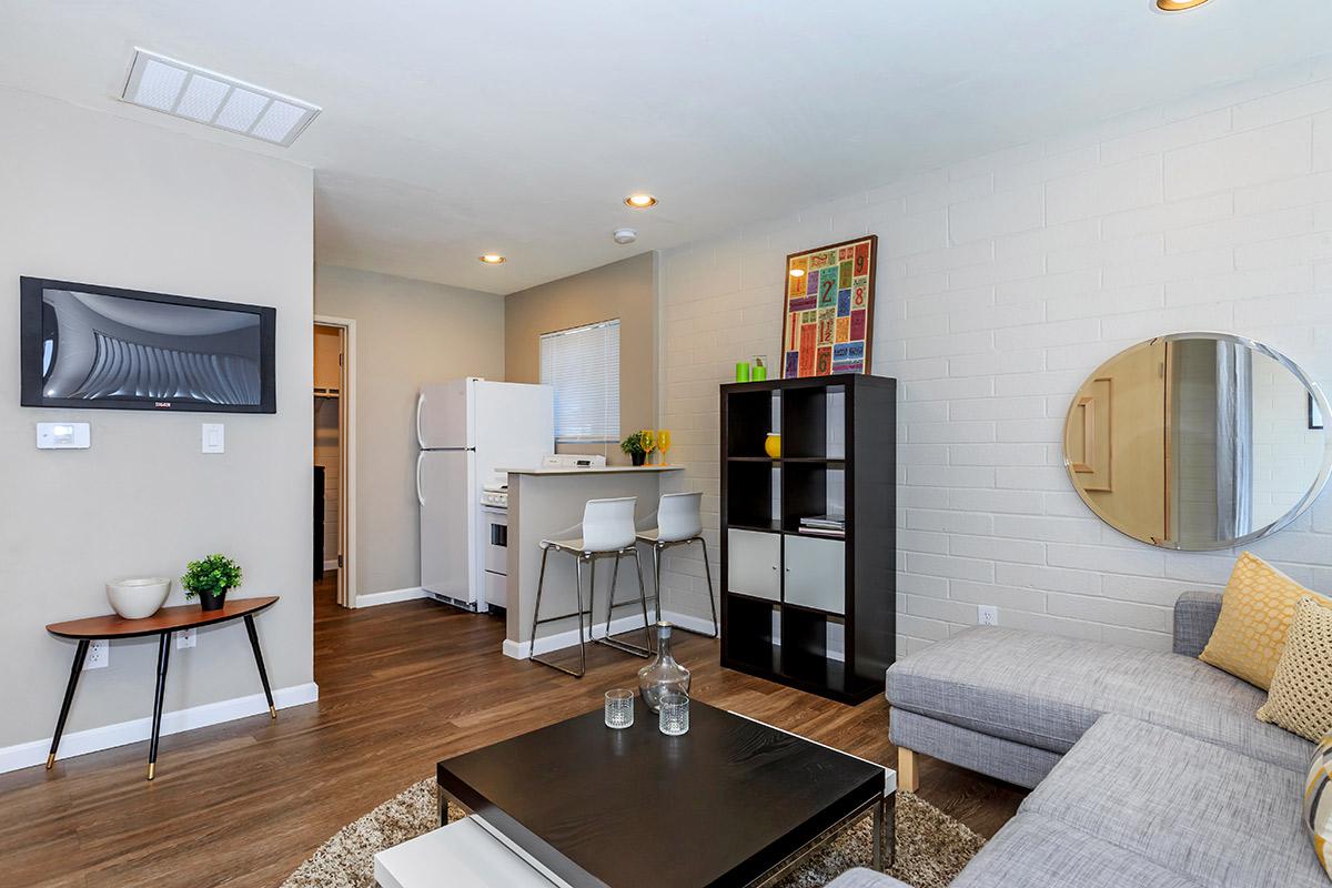 a living room filled with furniture and a flat screen tv