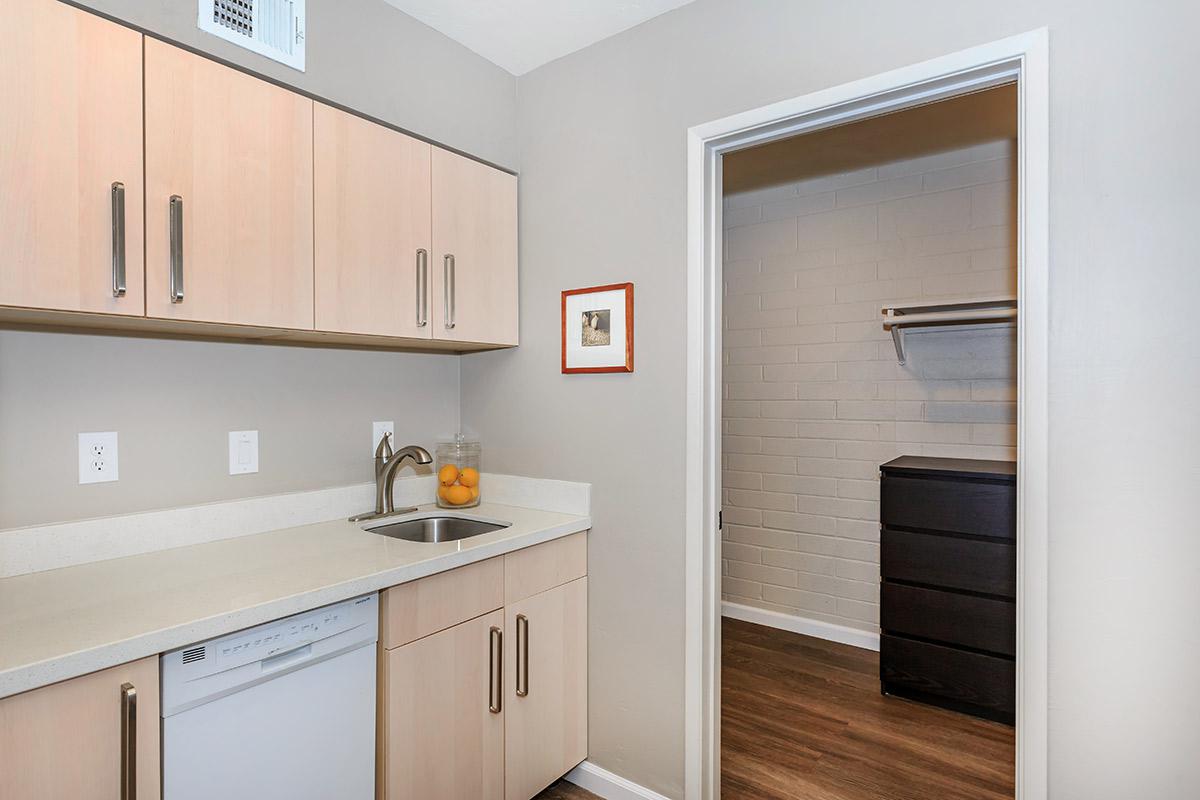 a kitchen with a sink and a mirror