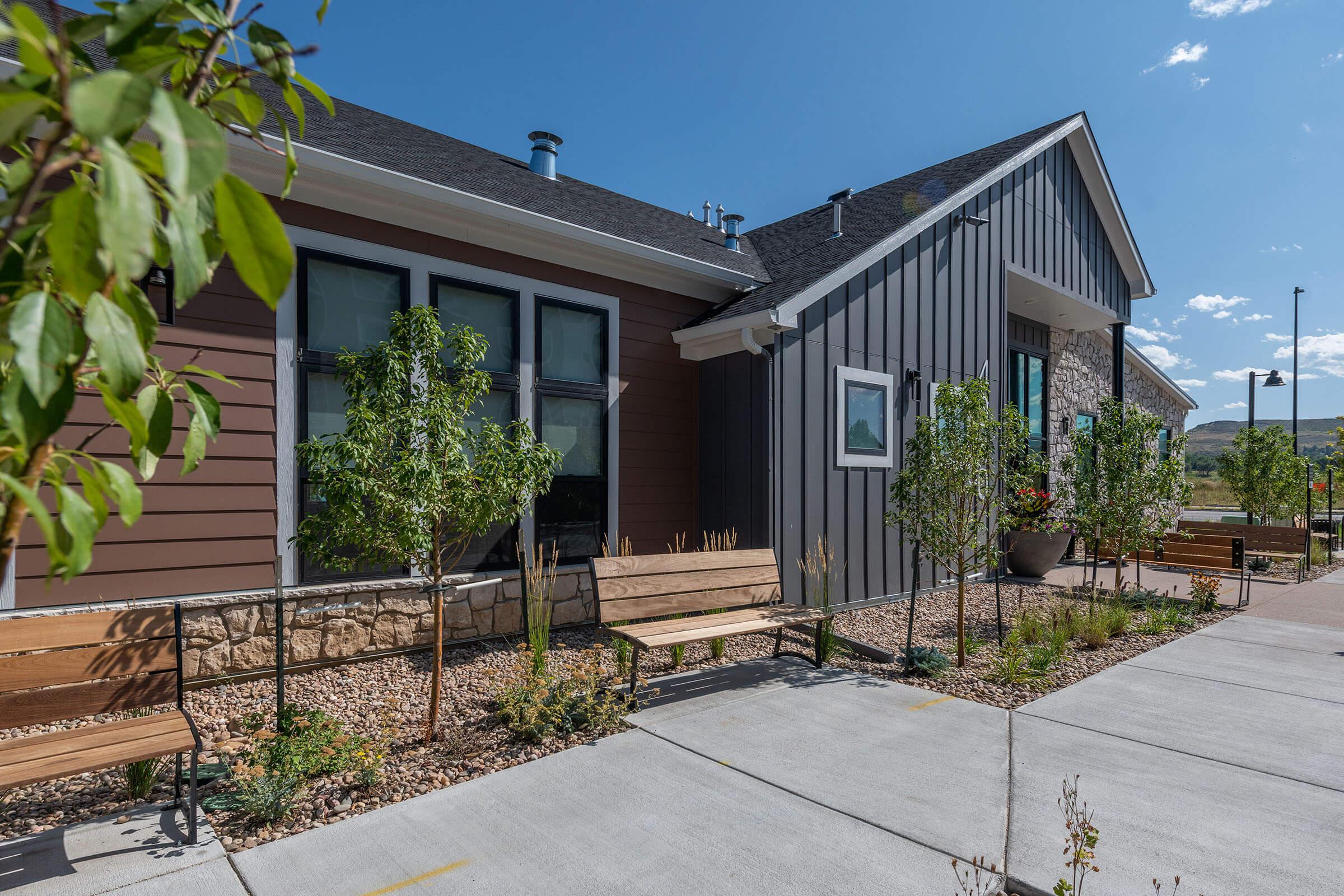 a house with a fence in front of a building