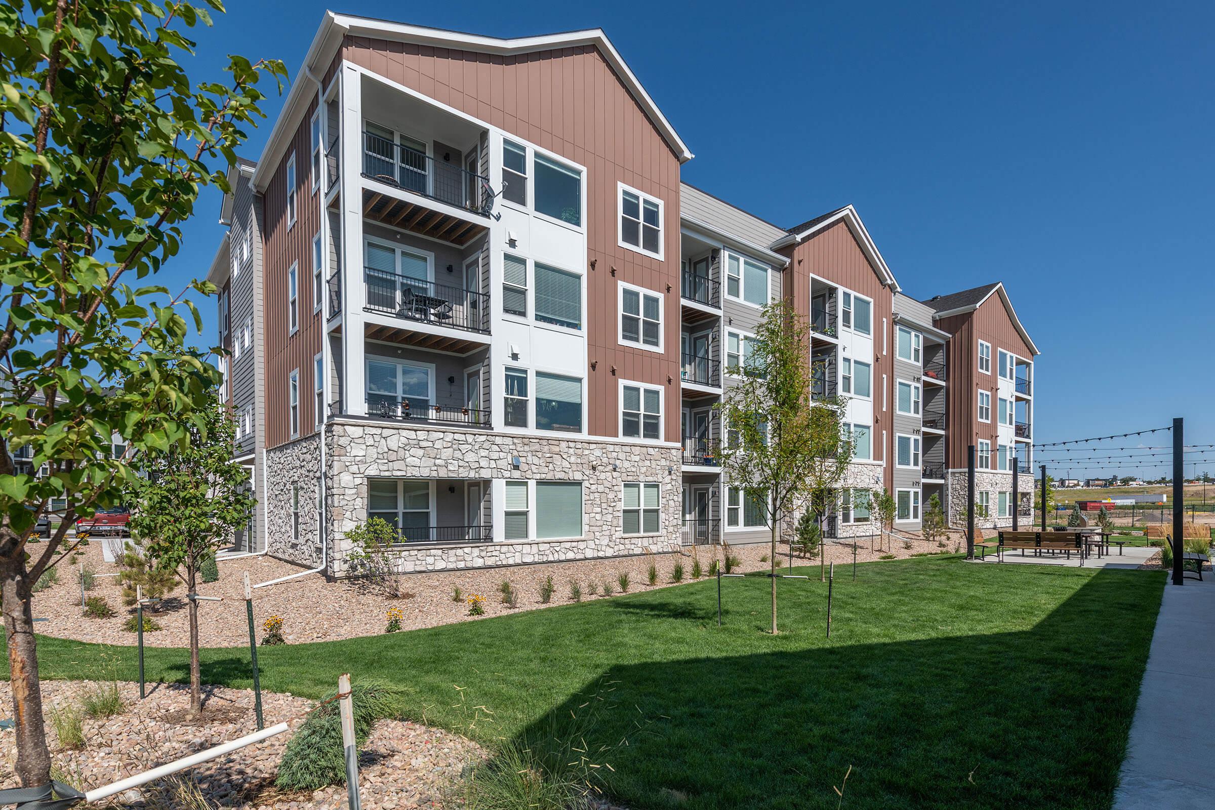 a large lawn in front of a brick building