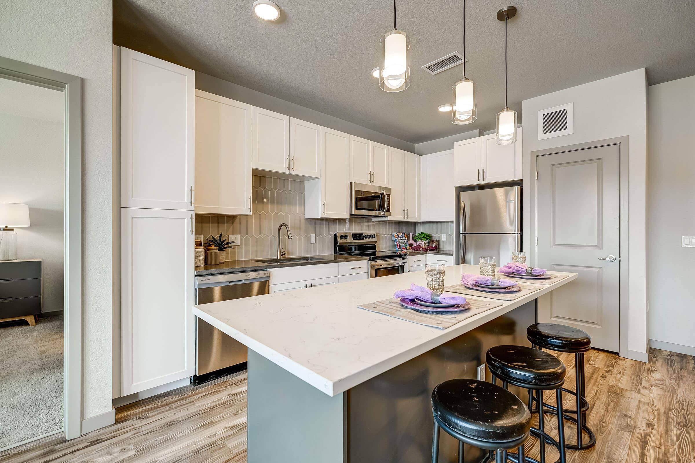 a kitchen with an island in the middle of a room