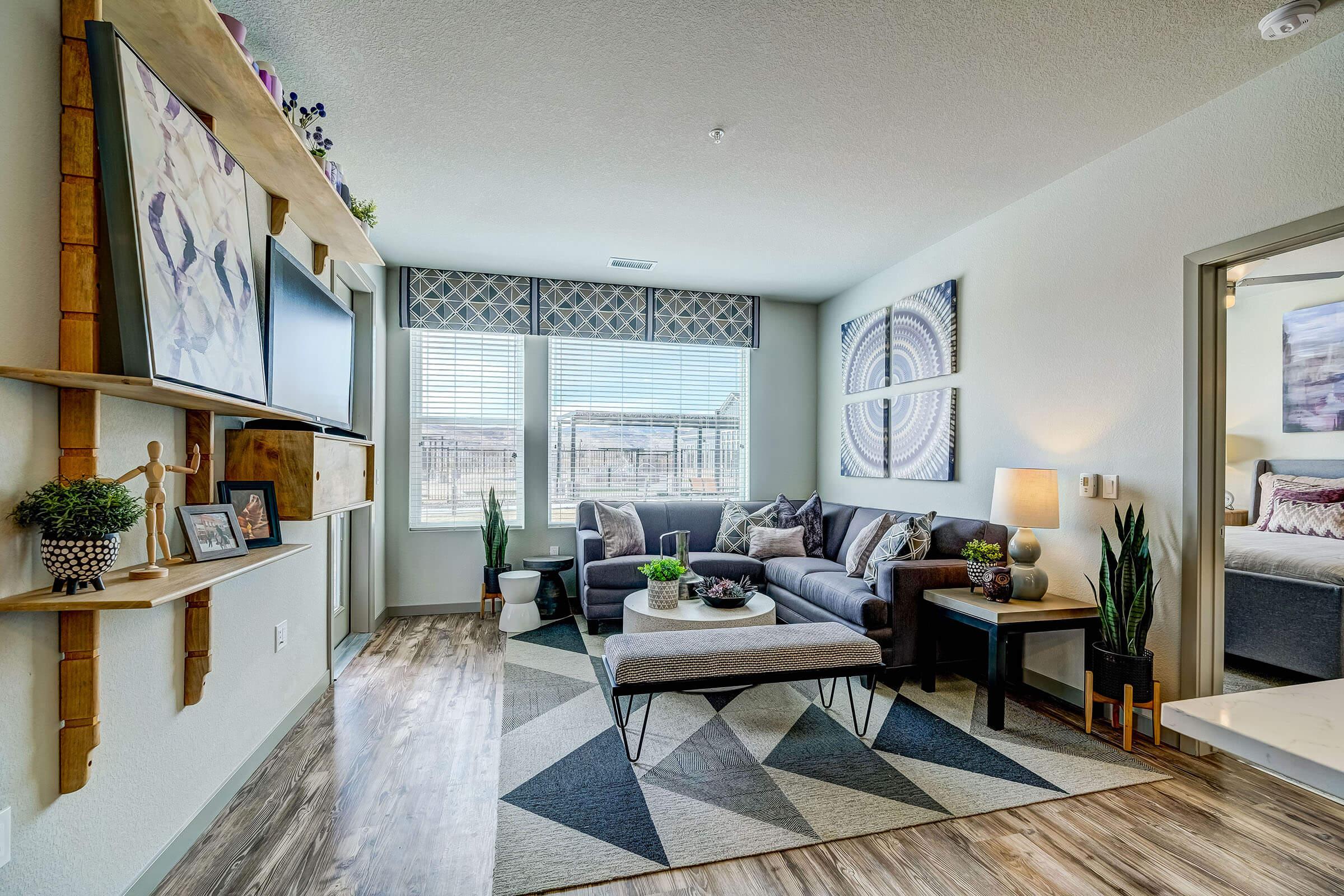 a living room filled with furniture and a large window