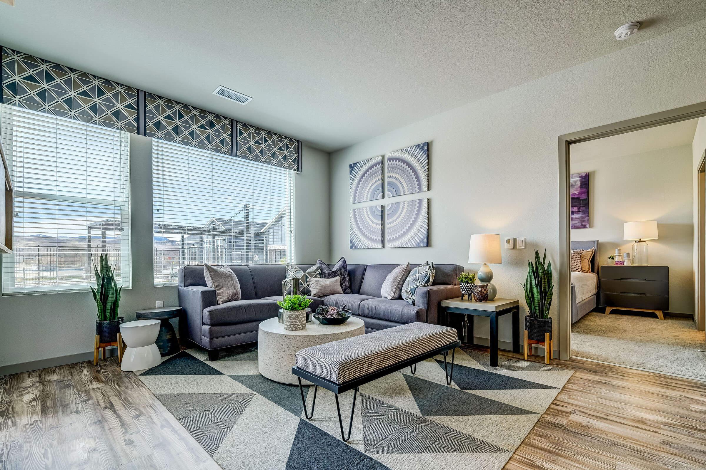 a living room filled with furniture and a large window