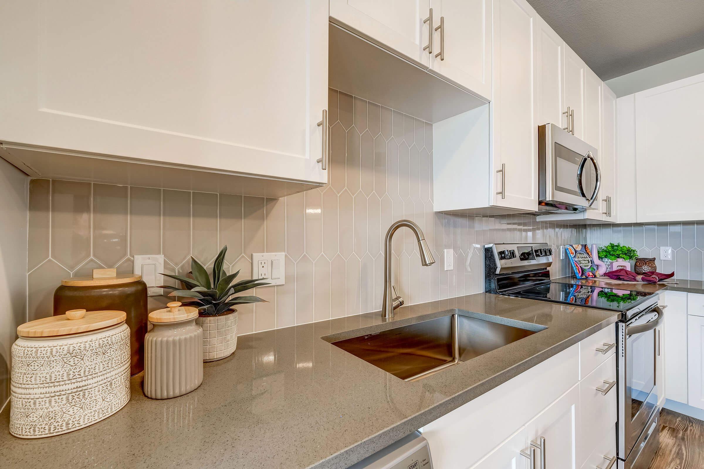 a kitchen with a sink and a microwave