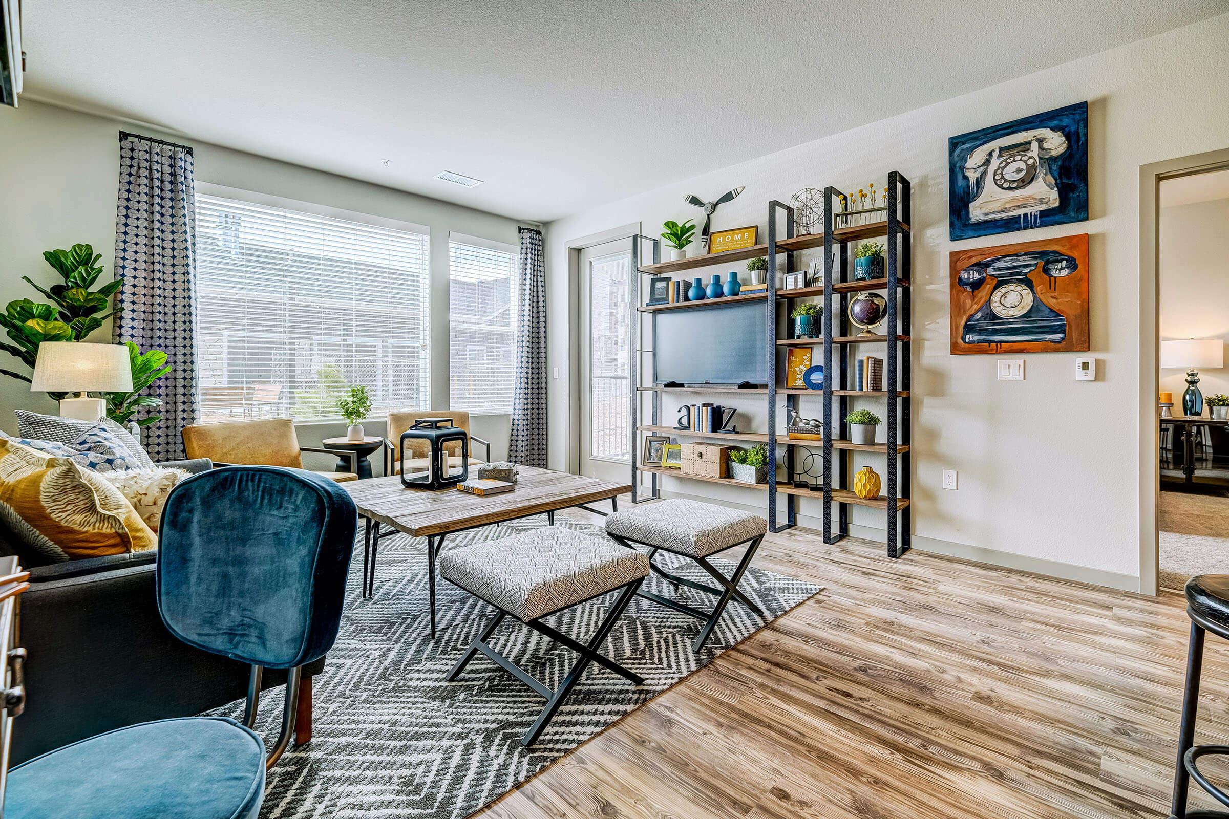 a living room filled with furniture and a large window