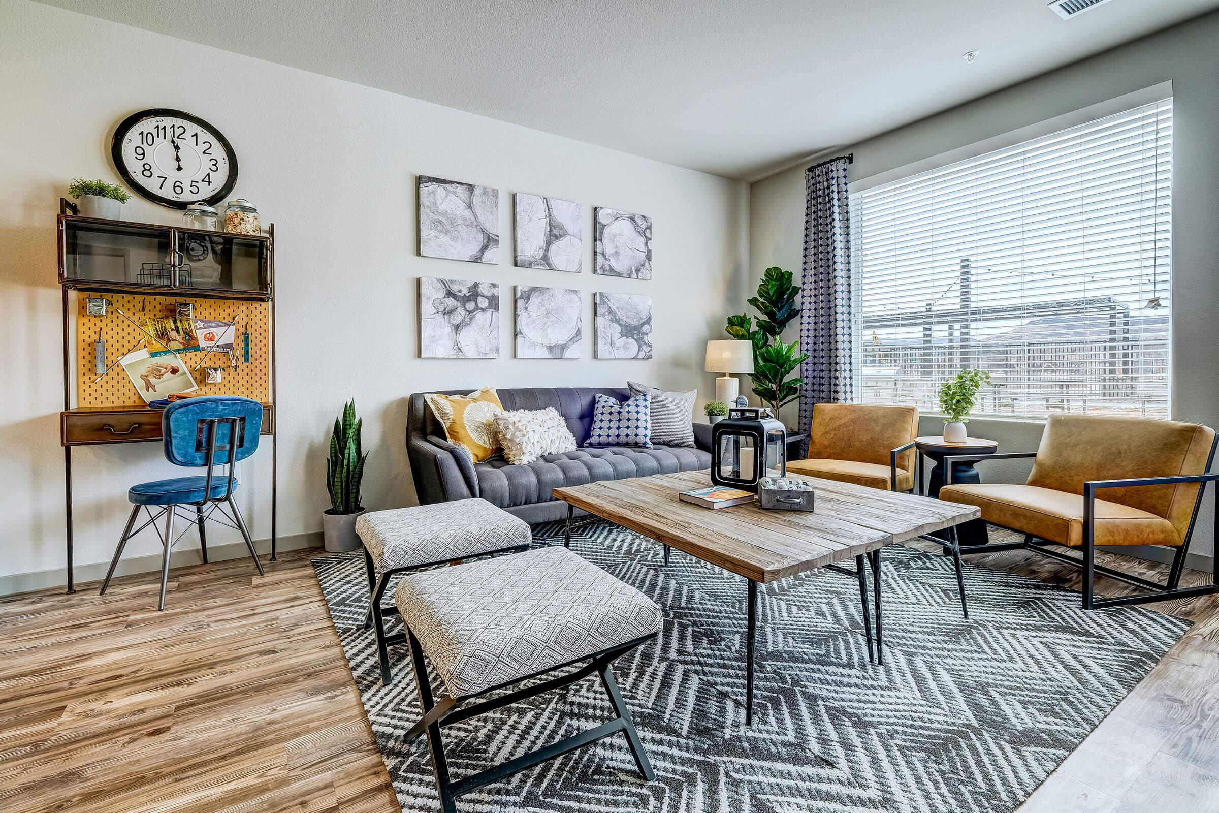 a living room filled with furniture and a large window