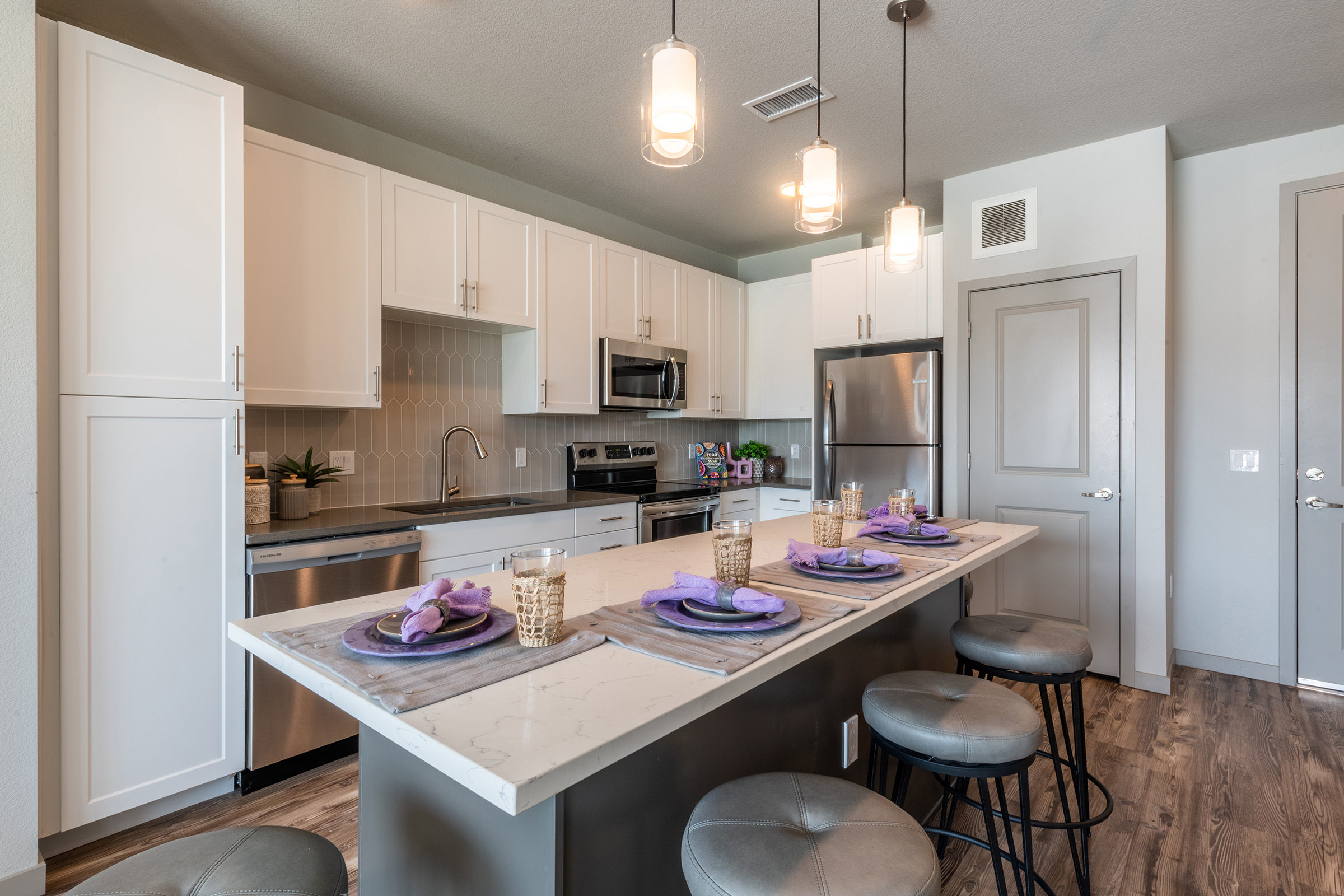 a kitchen with an island in the middle of a table