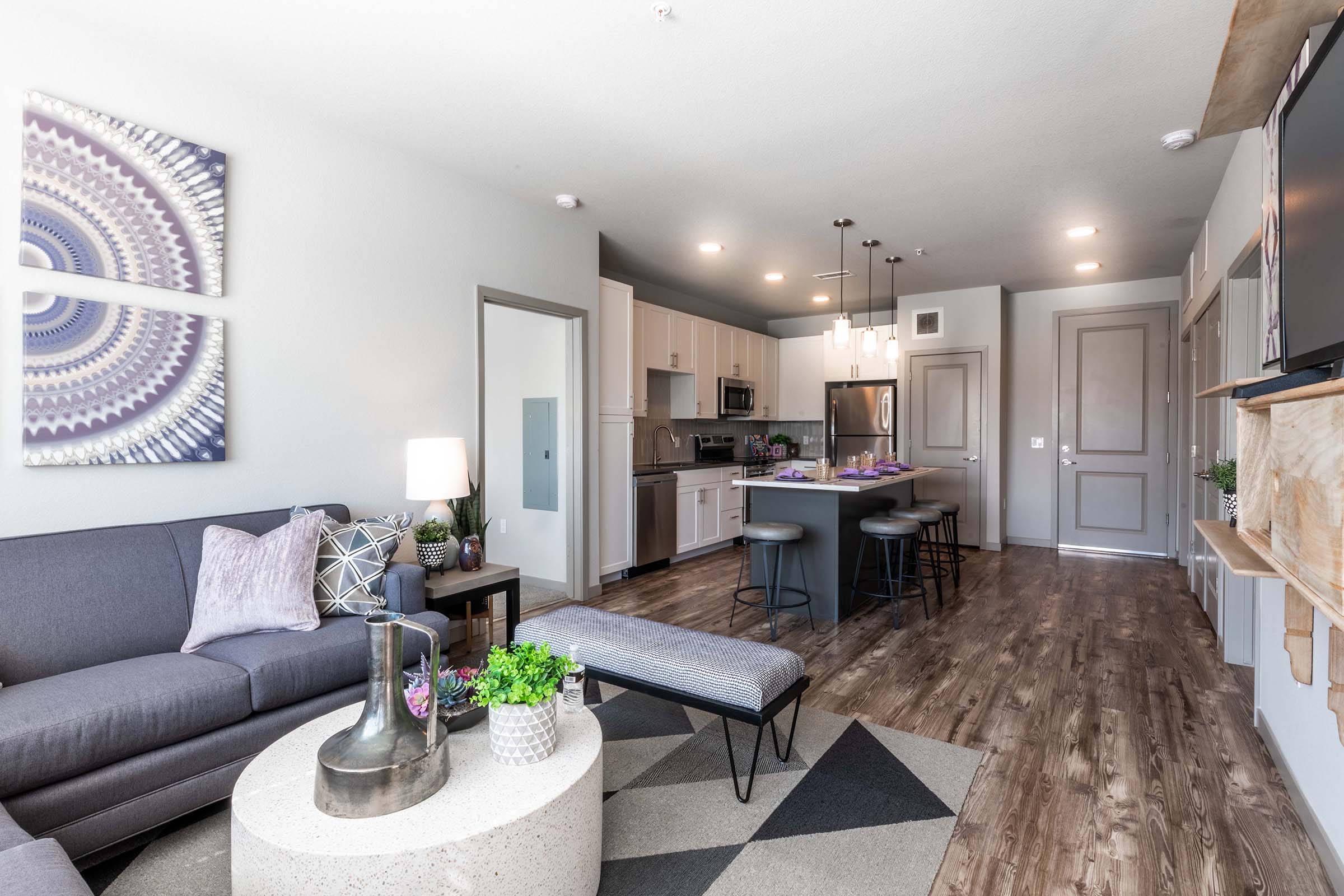 a living room filled with furniture and a flat screen tv