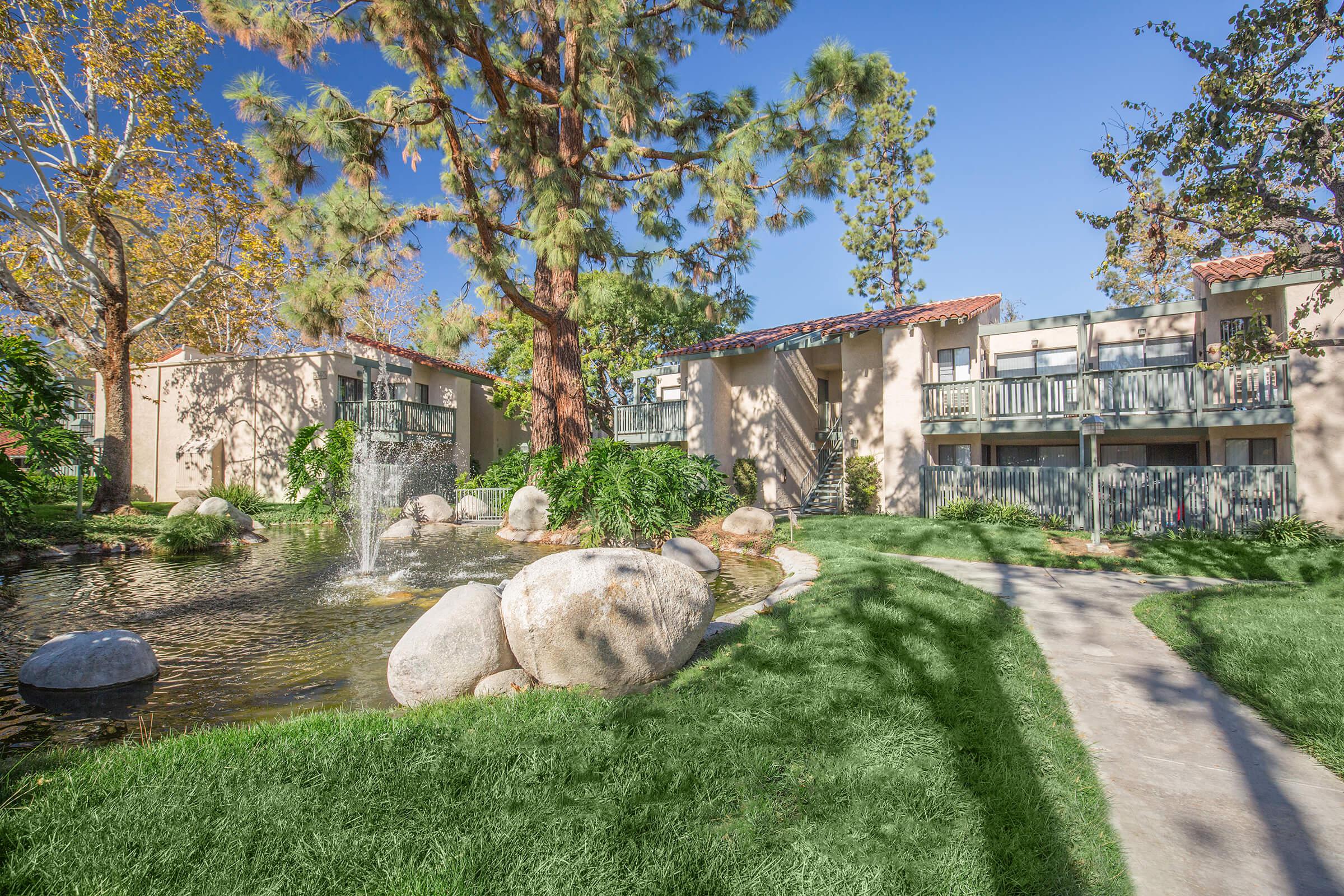 McComber Creek Apartment Homes community buildings with green grass