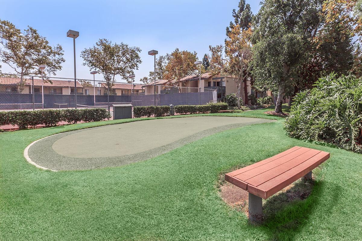 Wooden bench next to tennis court