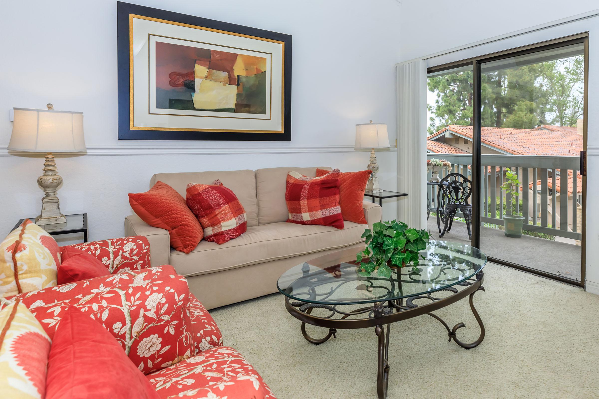 a living room filled with furniture and a large window